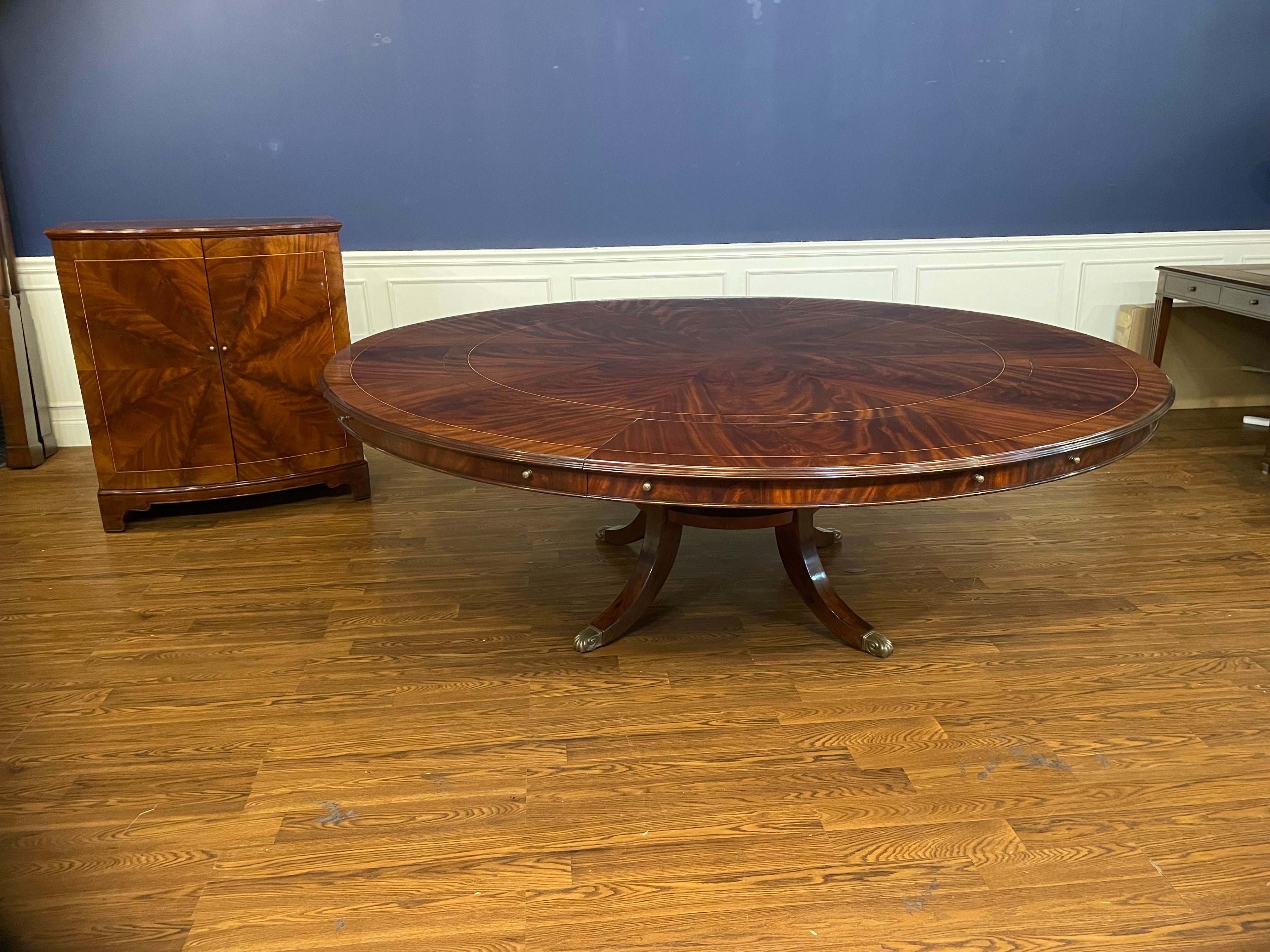 This is a magnificent large round dining/banquet table with a matching leaf storage cabinet.  This is a Leighton Hall prototype table and cabinet (First one we’ve made of this design).  The table features a field of radial cut swirly crotch mahogany