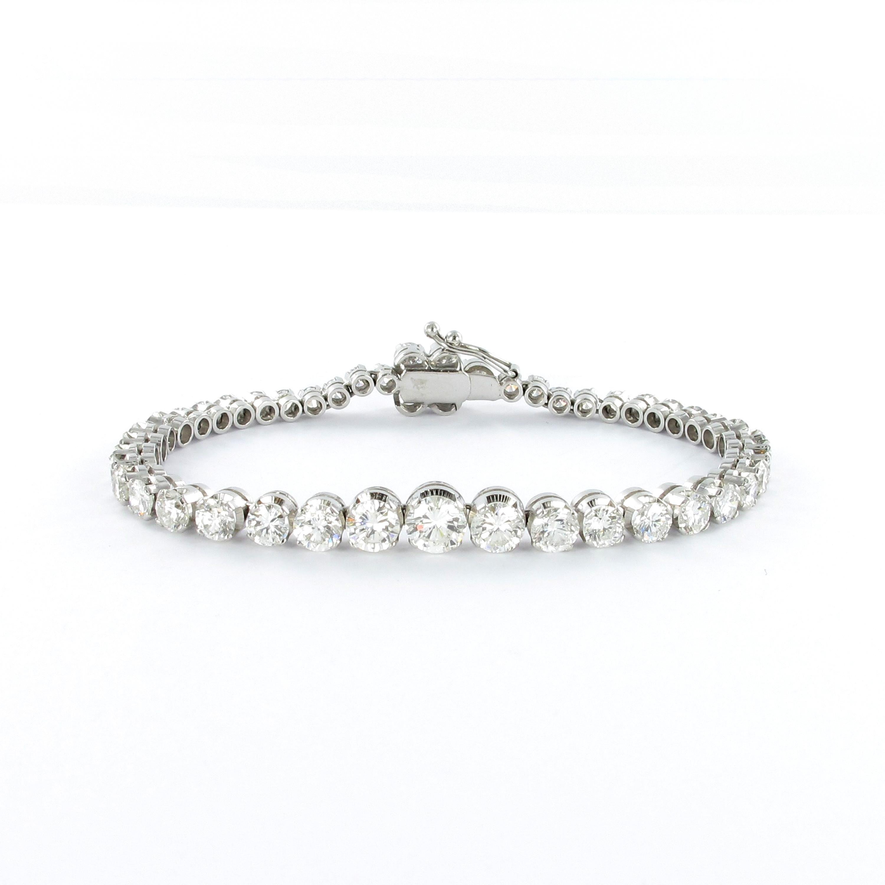 Classic tennis bracelet in 18 karat white gold. Prong set with 48 graduated brilliant cut diamonds of G/H color and si clarity. Diamonds ranging from 0.05 to 0.56 ct in individual weights adding up to a total of approximately 9.00 carats. Lovely box