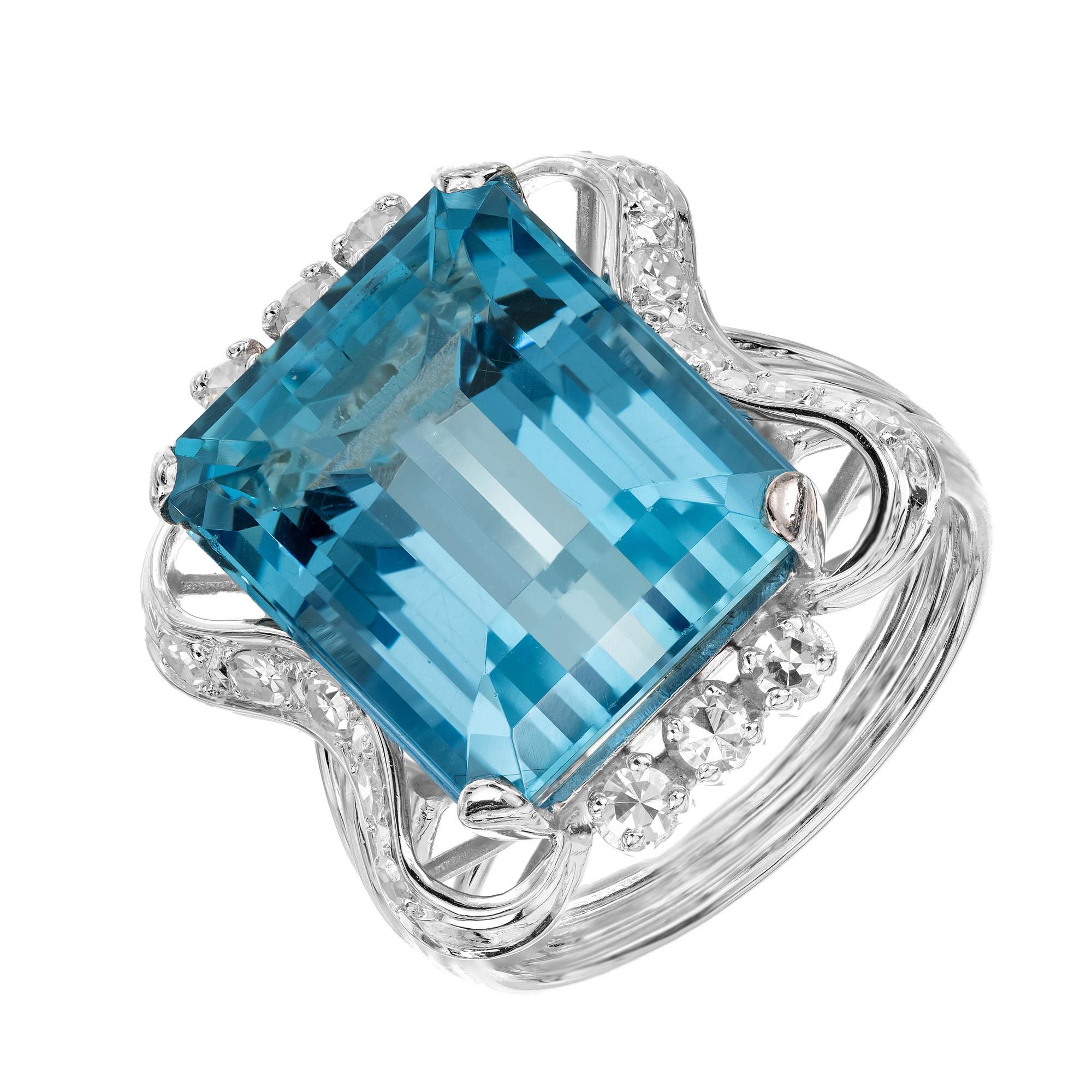 Stunning 1950's aqua and diamond cocktail ring. Rich blue spectacular 10.83 emerald cut Aquamarine center stone, mounted in a highly detailed 18k white gold setting. The aqua is accented with 16 round single cut diamonds in a dazzling setting.  The