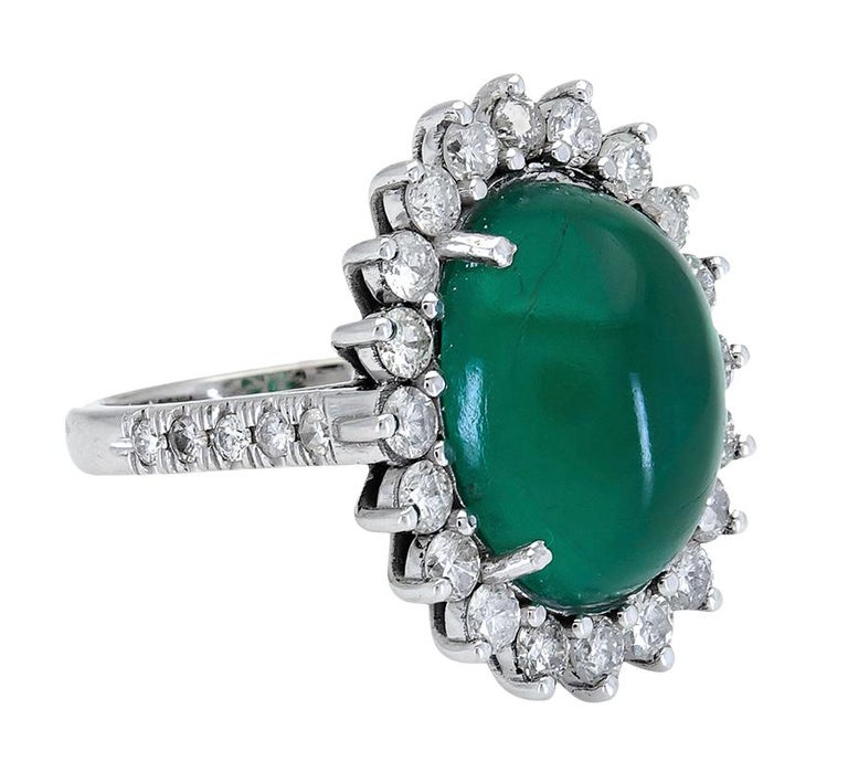 A vibrant and elegant cocktail ring perfect for an important event or gala. Features an oval cabochon emerald set in a floral motif halo made of diamonds. Made in 18k white gold.
Green emerald weighs 9.00 carats.
Diamonds weigh 2.00 carats and are