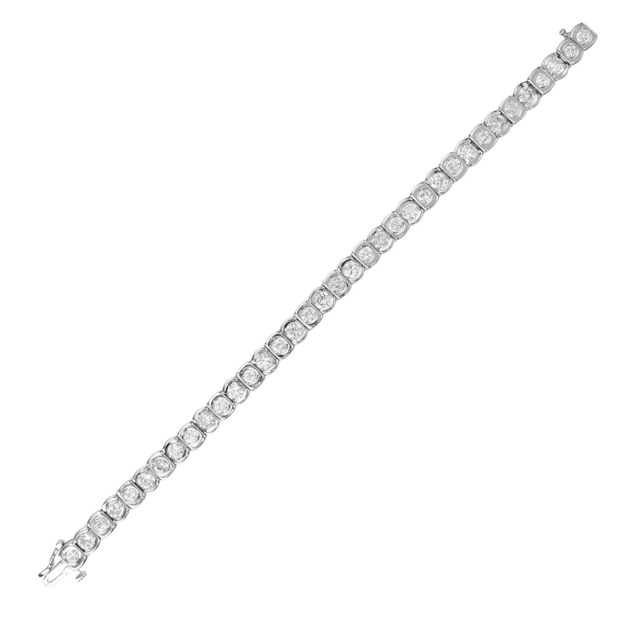 Modern 14k white gold bracelet flush set with 36 round brilliant cut semi bezel diamonds with an approximate weight of 9.00cts of alternating sized diamonds. How the diamonds are positioned throughout the bracelet creates a unique effect that can