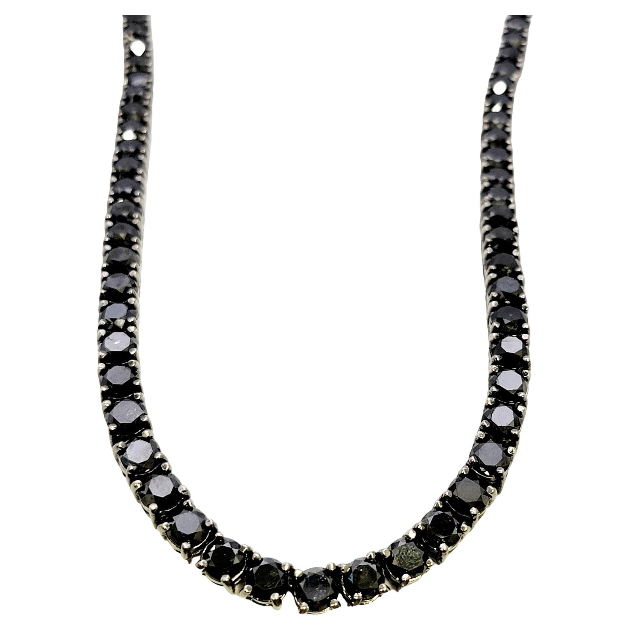 This is an absolutely jaw-dropping black diamond tennis necklace that will stand the test of time. The simple yet elegant design paired with the timeless round diamonds makes this piece a true classic that will never go out of style. 

This stunning