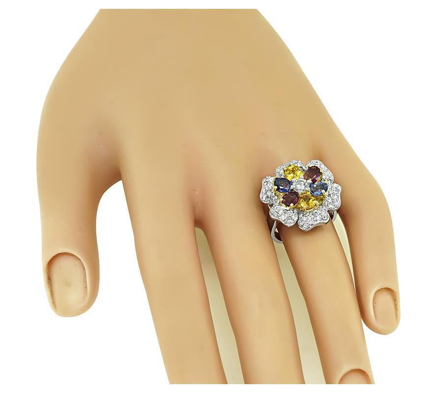 This is a stunning 18k white gold ring and earrings set. The set features lovely oval cut multi color sapphires that weigh approximately 9.00ct. The sapphires are accentuated by sparkling round cut diamonds that weigh approximately 3.60ct. The color