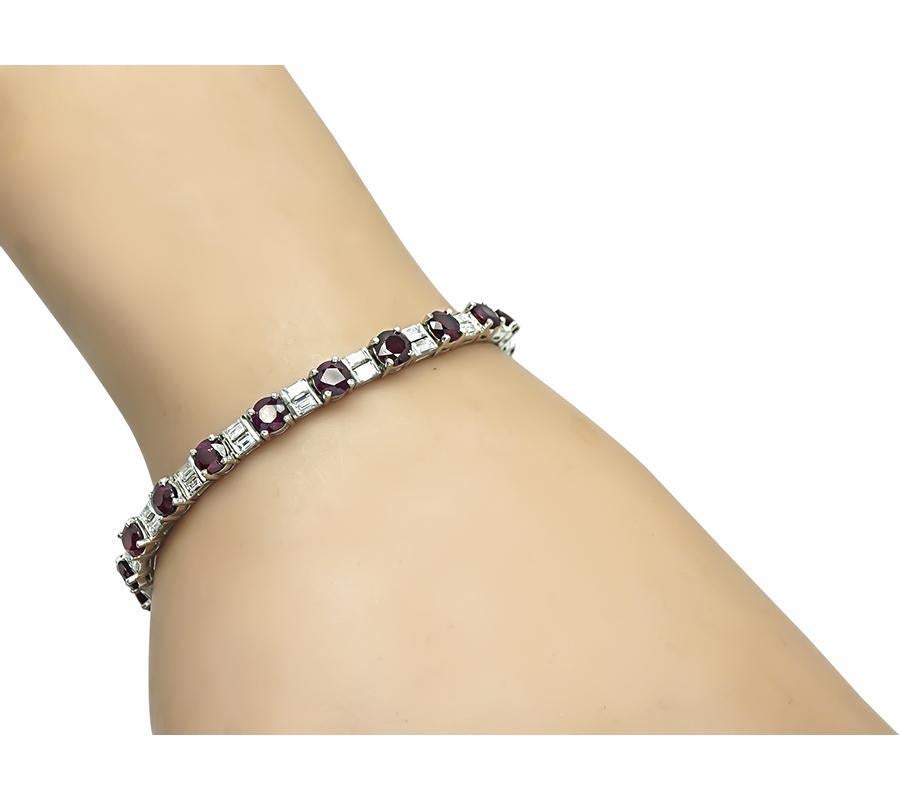 This is an elegant platinum bracelet. The bracelet is set with lovely round cut rubies that weigh approximately 9.00ct. The rubies are accentuated by sparkling baguette cut diamonds that weigh approximately 1.75ct. The color of these diamonds is F-G