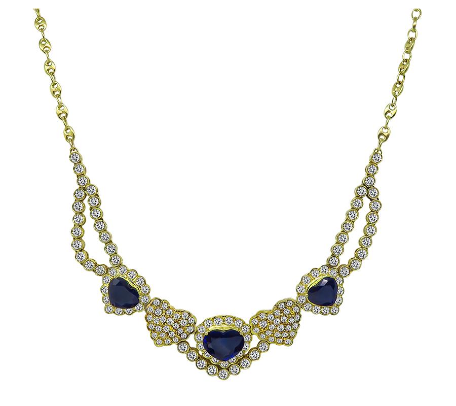 This is an amazing 18k yellow gold necklace and earrings set. The set features lovely heart shape sapphires that weigh approximately 9.00ct. The sapphires are accentuated by sparkling round cut diamonds that weigh approximately 7.00ct. The color of