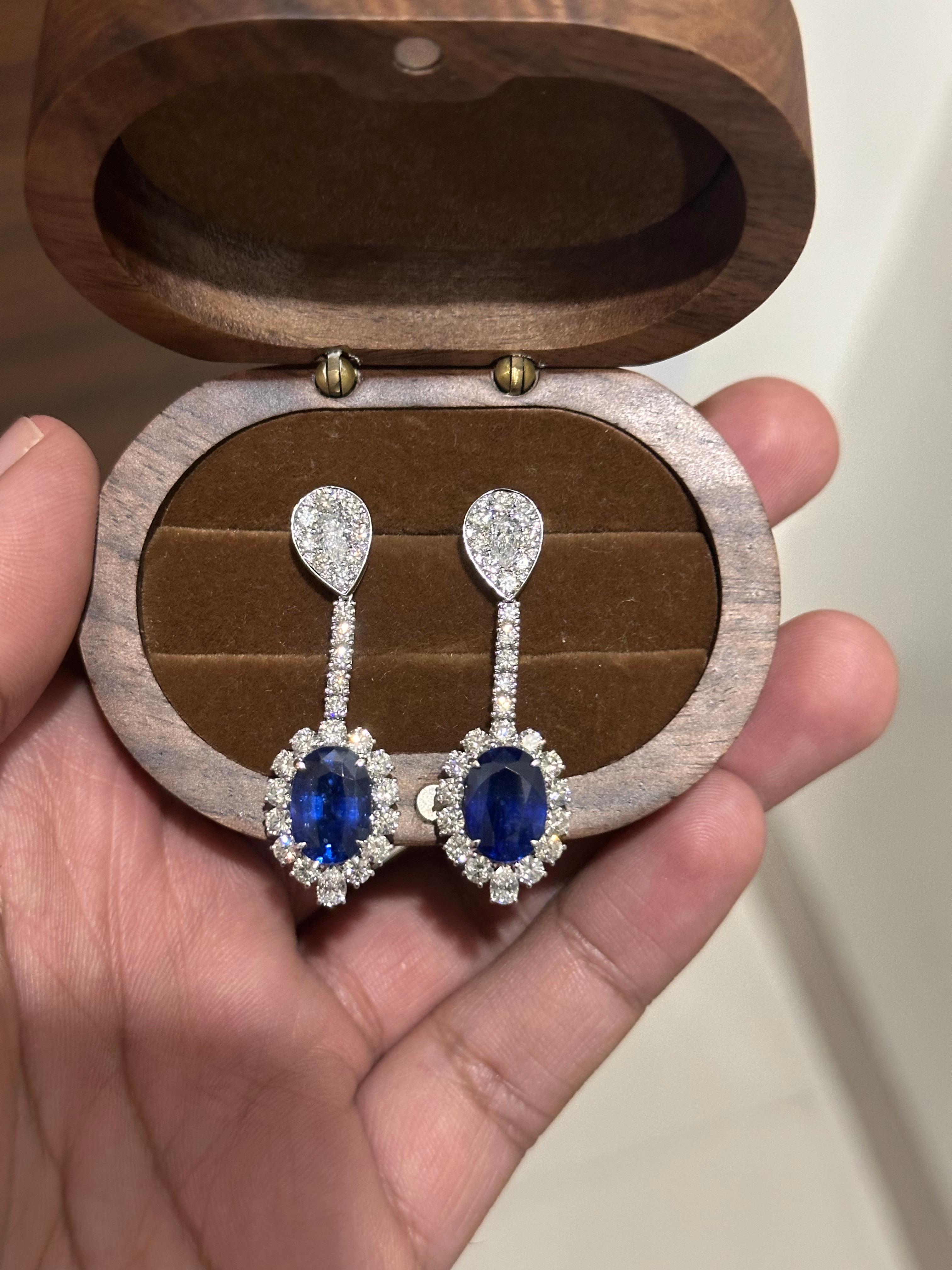 A breathtaking harmony of color and brilliance, these exquisite earrings feature a pair of vivid Sri Lankan blue sapphires, totaling 9.01 carats, expertly cut in elegant ovals and certified heated to enhance their deep, velvety hue — a treatment