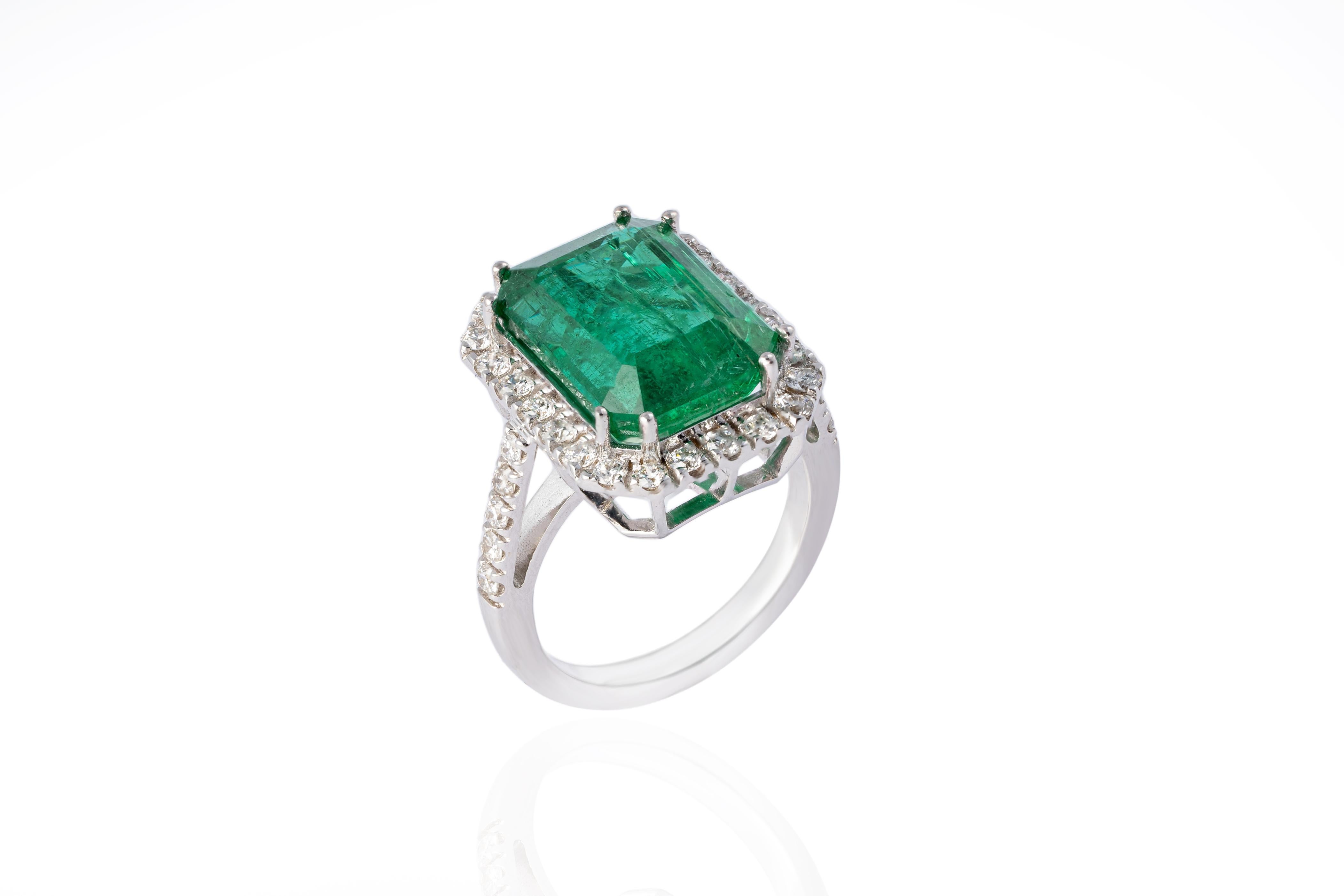 Introducing our exquisite 14 Karat White Gold Ring featuring a stunning 9.01 carat natural Zambian Emerald and 0.83 carats of diamonds. This ring is truly remarkable, showcasing the beauty of the emerald and the brilliance of the diamonds.

Crafted