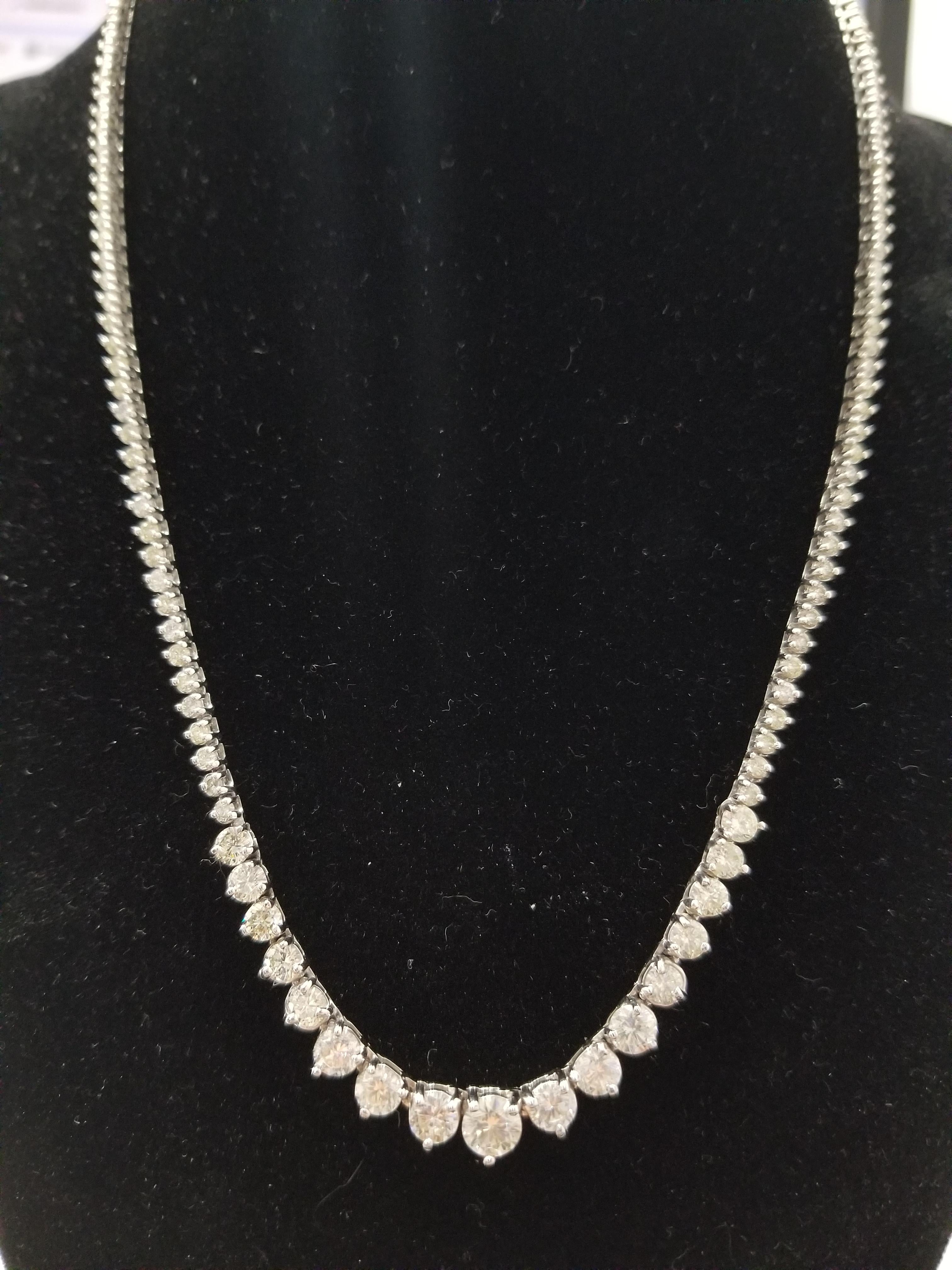 Stunning 14 Karat White Gold Round Brilliant Cut Diamond Tennis Necklace set on 3- prong setting. The total diamond weight is 9.05 carats. The closure is an insert clasp with safety clasp. Length is 18 inches. center stone 0.60ct. VERY SHINY EYE