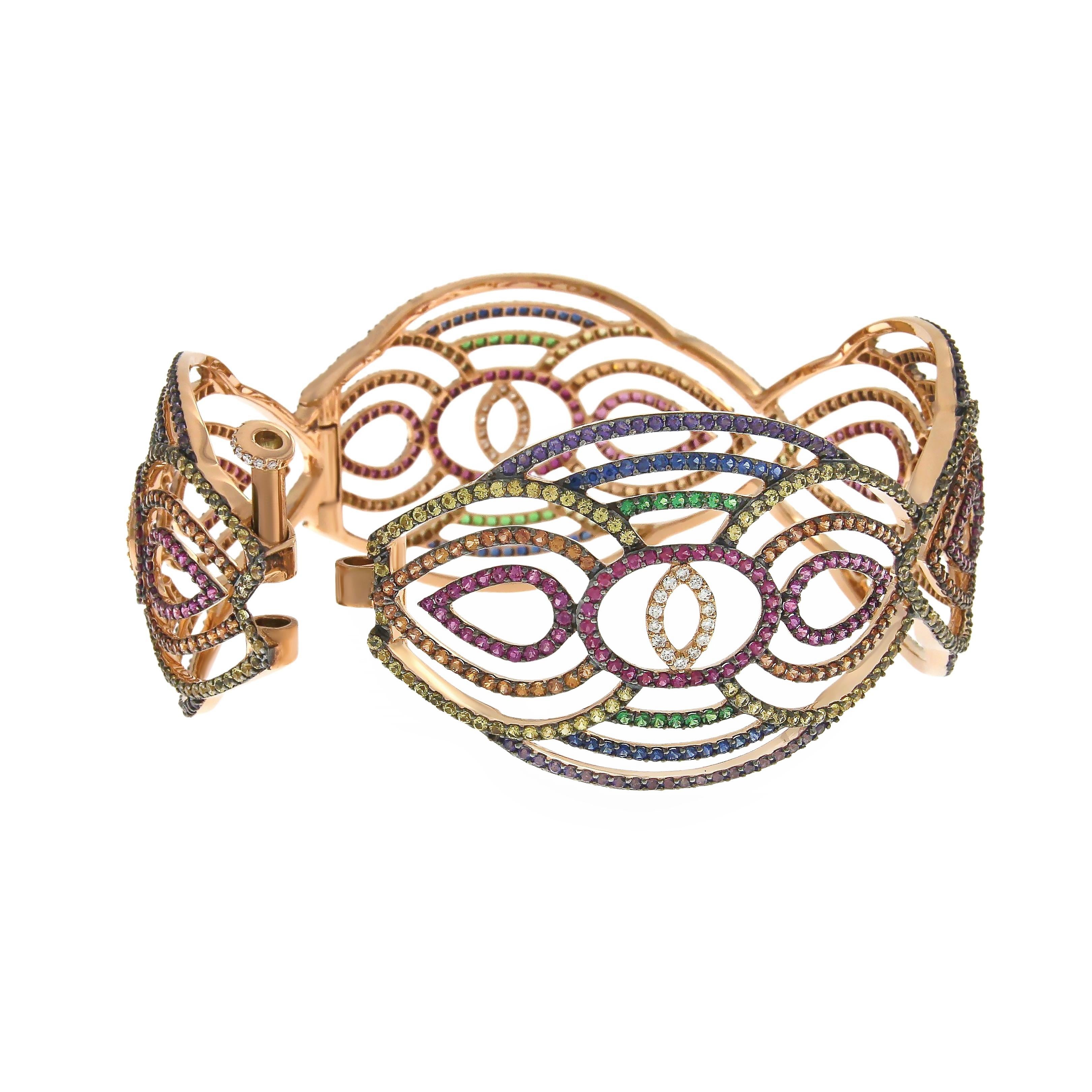 Indulge in the enchanting allure of our Rainbow Cuff, a dazzling testament to bespoke elegance. This exquisite piece features a fanciful motif adorned with a mesmerizing array of colored sapphires, ruby, tsavorites, violet tourmaline and diamonds,