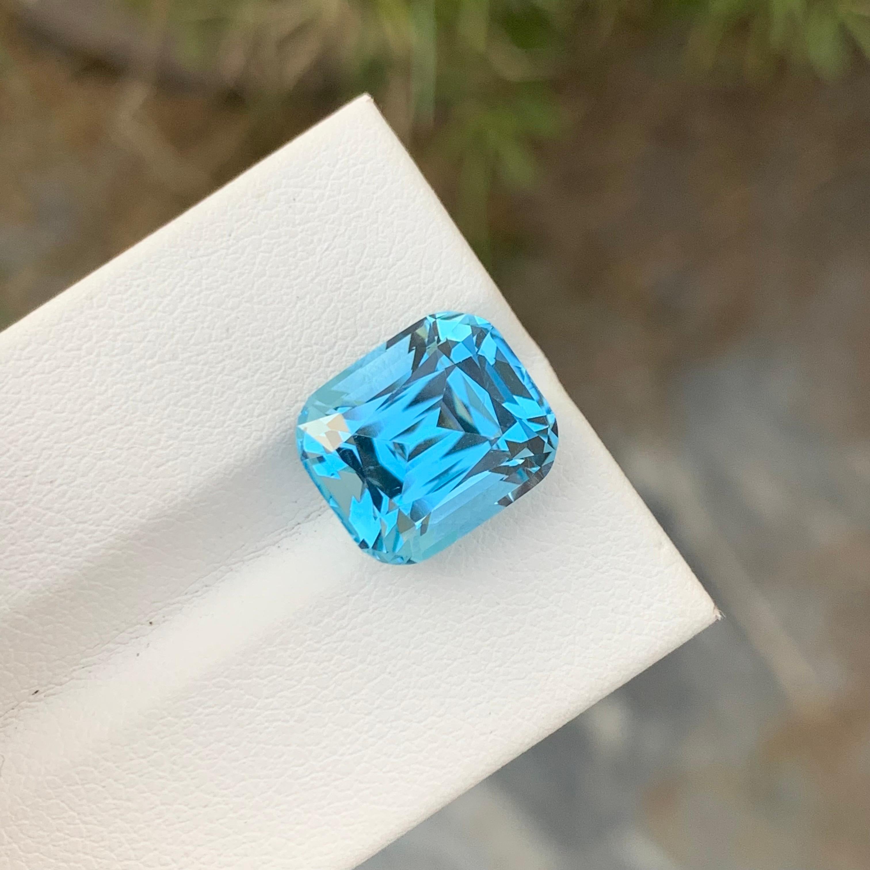 Loose Blue Topaz
Weight: 9.05 Carats
Dimensions: 12.4 x 10.6 x 8.3 Mm
Origin: Brazil
Shape: Cushion 
Color: Blue
Certificate: On Demand

Benefits Of Wearing Blue Topaz Stone:
It helps to improve communication and self-expression.
It provides inner