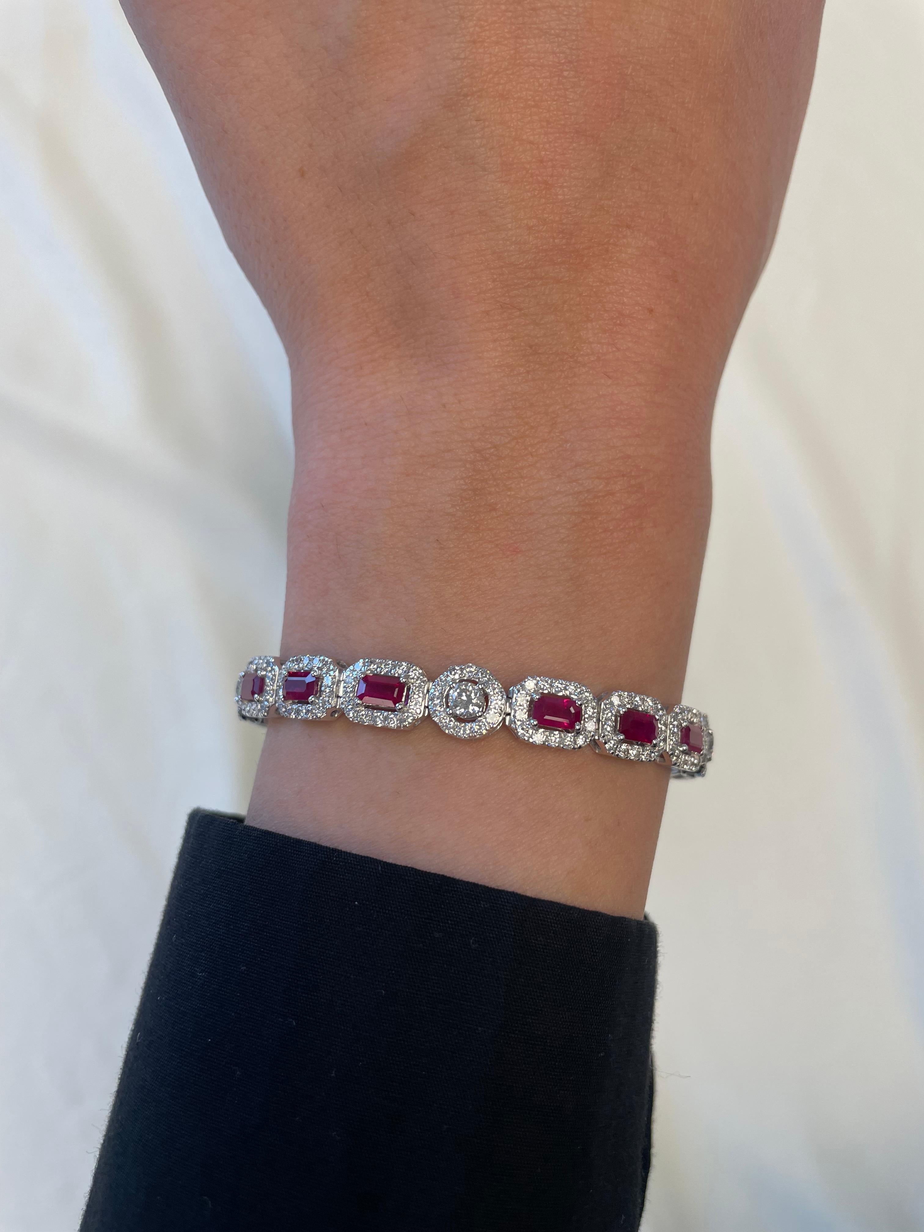 Exquisite and elegant ruby and diamond bracelet.
9.05 carats total gemstone weight.
15 emerald cut rubies, heat, 4.25 carats. Complimented by 4.80 carats of round brilliant diamonds, approximately G/H color and SI clarity. 14k white gold, 20.70