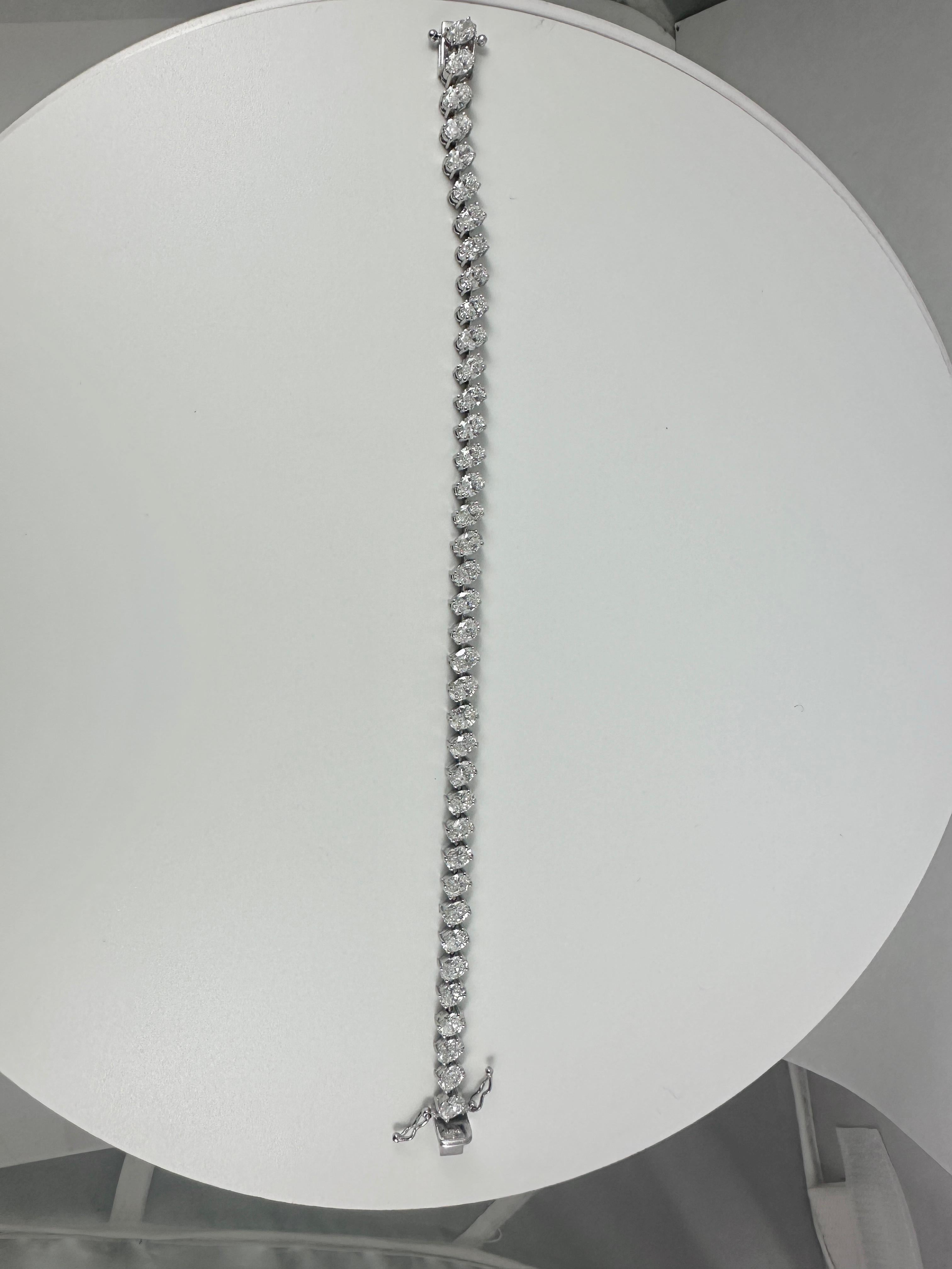This exquisite oval diamond tennis bracelet is a timeless symbol of elegance and refinement, crafted in radiant 14K white gold. Featuring a total of 9.06 carats of brilliantly cut oval diamonds, each stone is meticulously set to maximize brilliance