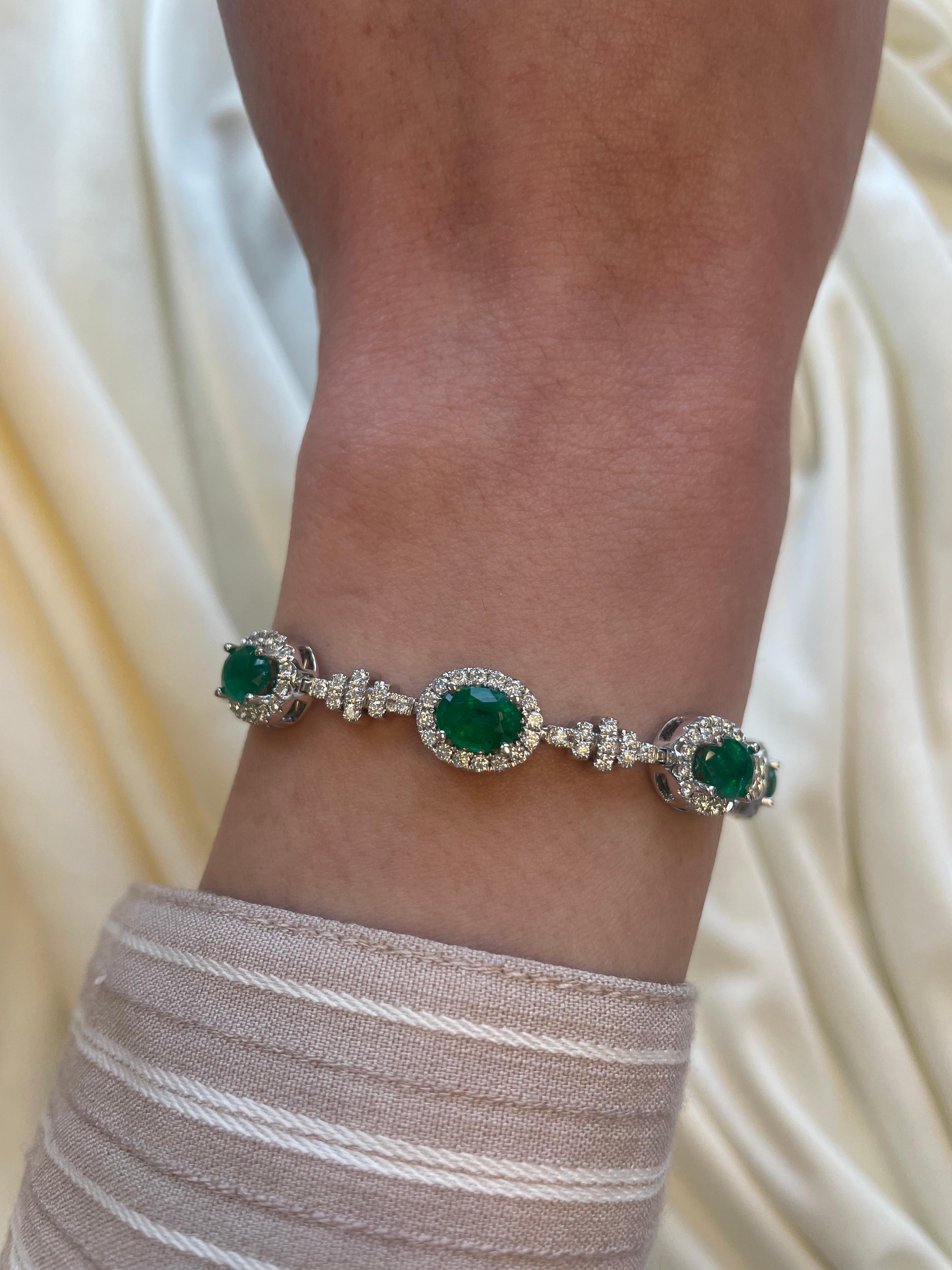 Exquisite and elegant emerald and diamond bracelet.
13.22 carats total gemstone weight.
9 oval cut emeralds, approximately F2, 6.57 carats. Complimented by 224 round brilliant diamonds, 2.51 carats. Approximately G/H color and SI clarity. 18k white