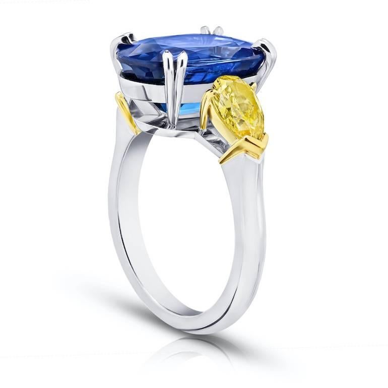 9.08 carat Oval Blue Sapphire with pear shaped natural fancy yellow diamonds weighing 1.37 carats all set in hand made platinum and 18k yellow gold ring.
