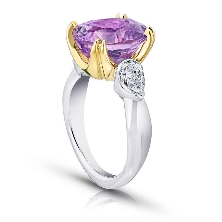 9.08 carat oval pink sapphire set with two pear shape diamonds (F+/VS+) weighing .82 carats set in a platinum and 18k yellow gold hand crafted ring.   
