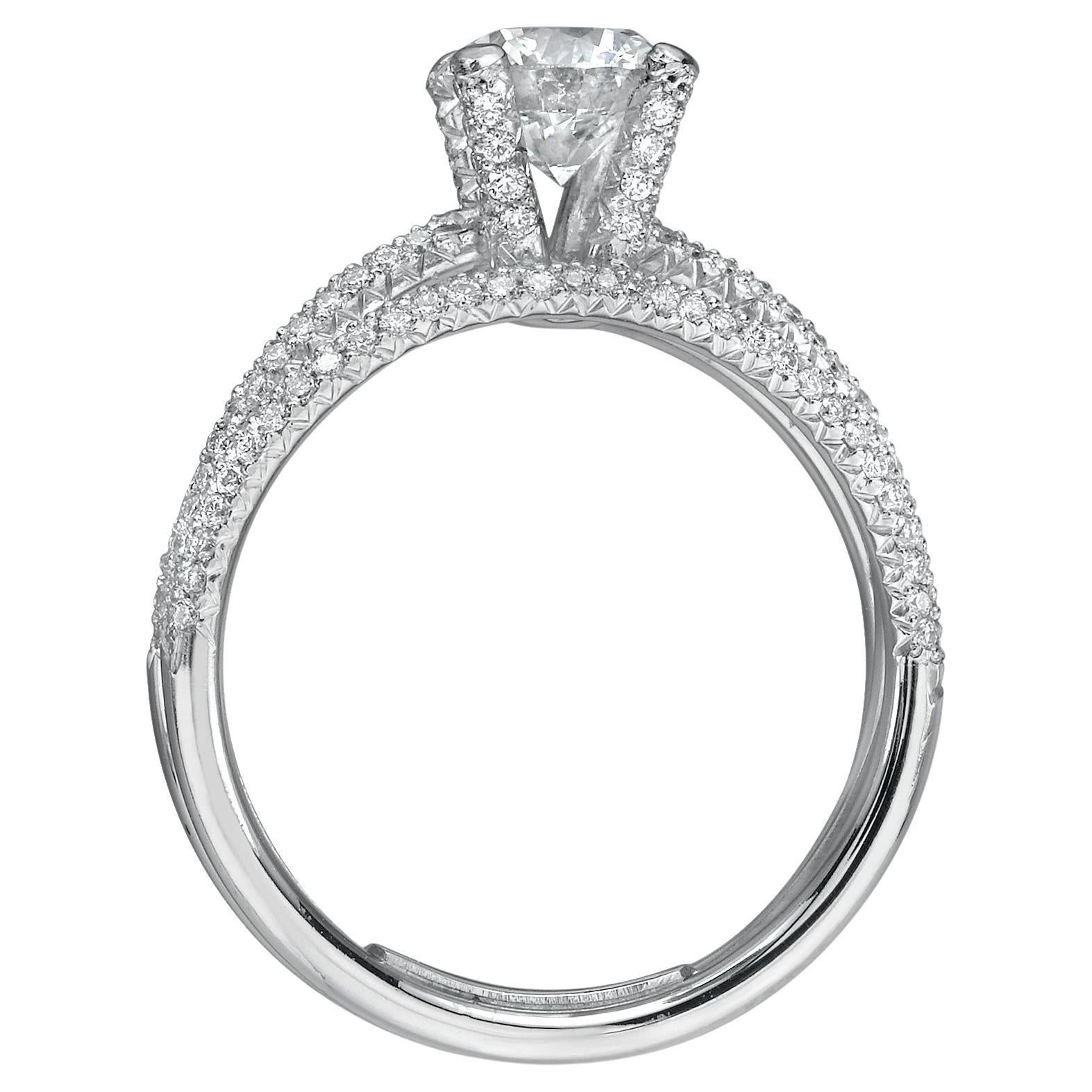 This stunning engagement ring exudes elegance and timelessness. Crafted from premium Platinum, the triple band mounting glistens with 0.40 CTs of shimmering white diamonds, highlighting the central 0.90 CT diamond with HSI1 clarity. The ring's