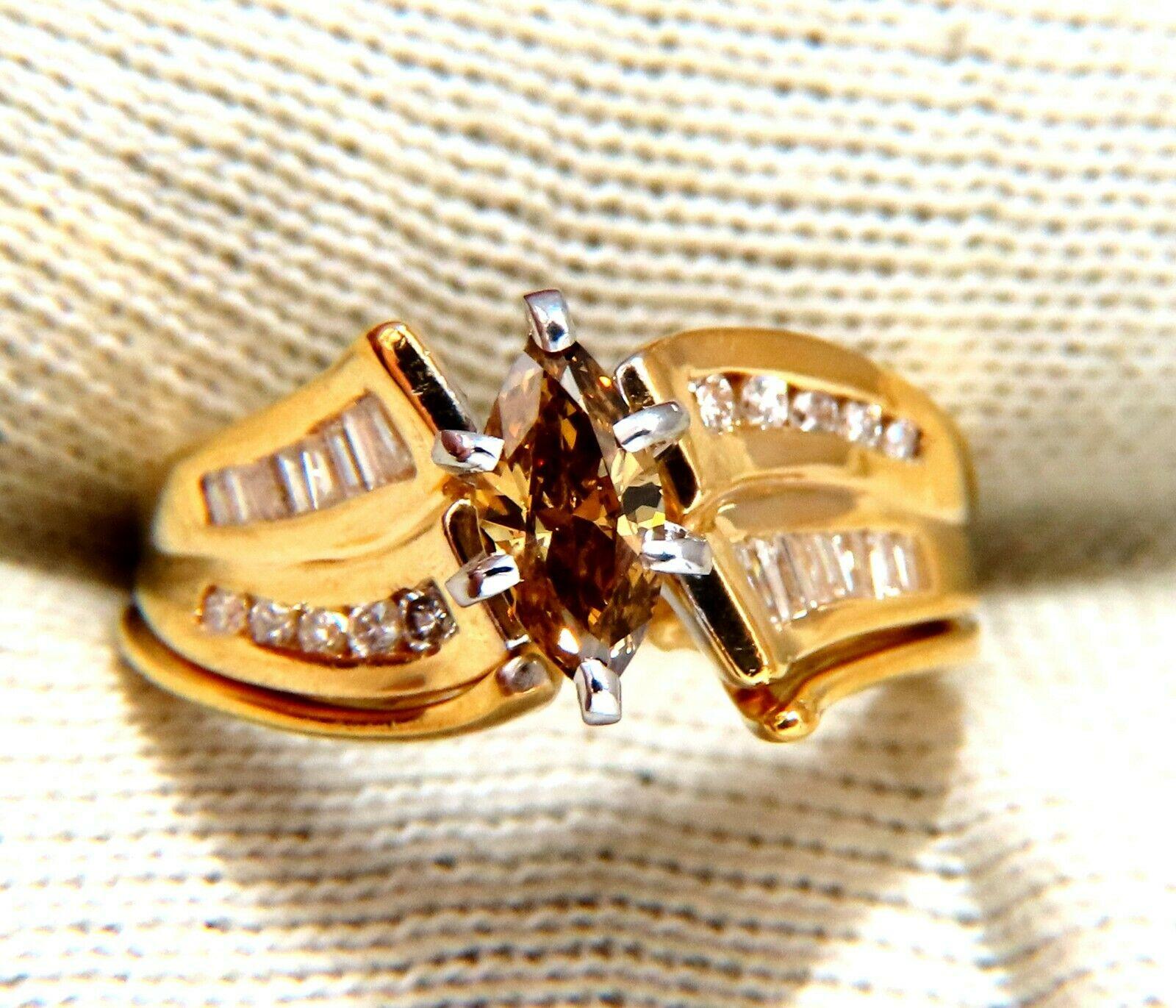 Halo Raised Solitaire

.40ct Natural Fancy Orange Brown Marquise Diamond. 

Vs-2 clarity.

.50ct. Side natural round & Baguette diamonds:

Si-1 Clarity I-color.

Ring measures: 

 9mm wide

8mm Depth

Size 6

14kt. yellow gold.

5.2 Grams

Resizing