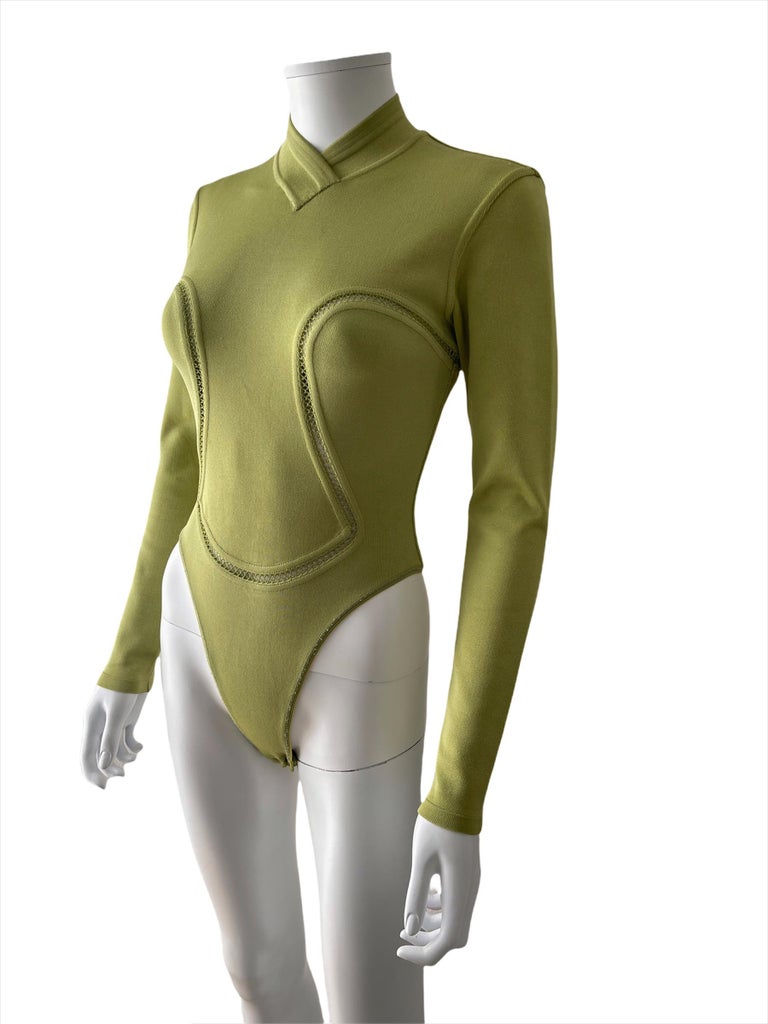 Azzedine Alaïa, Made in Italy, FW 1991.
Beautiful light green bodysuit with high V neckline, long sleeves and stitch details. 
Closes in the back with a zipper. 
The fabric is made from viscose (90%), polyamide and spandex. 
Size is S true to size,