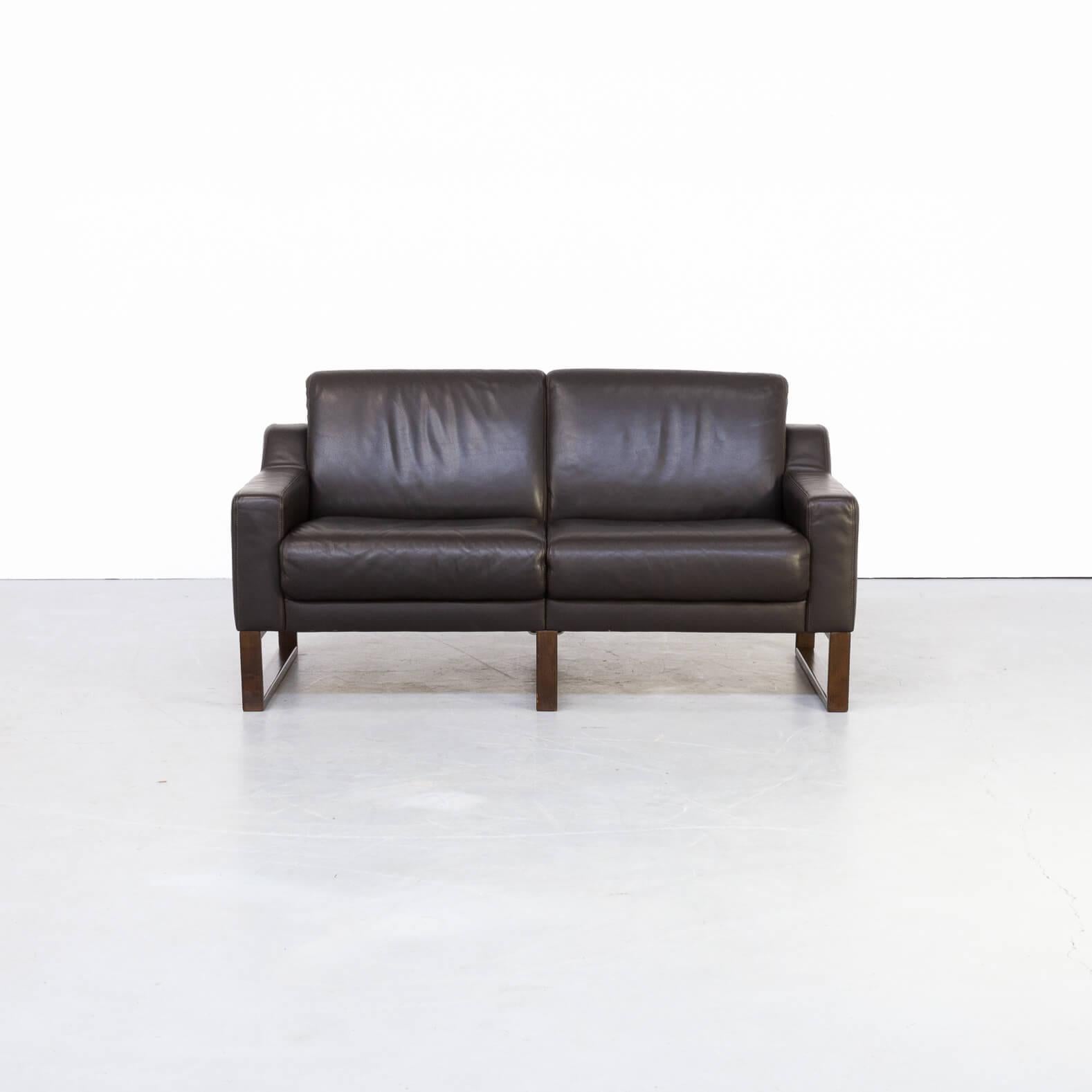 Beautiful brown leather two-seat sofa. The sofa has a wooden frame on which the comfortable leather seating is based. Gives a great spacious look and feel. The set is in good condition consistent with age and use!
