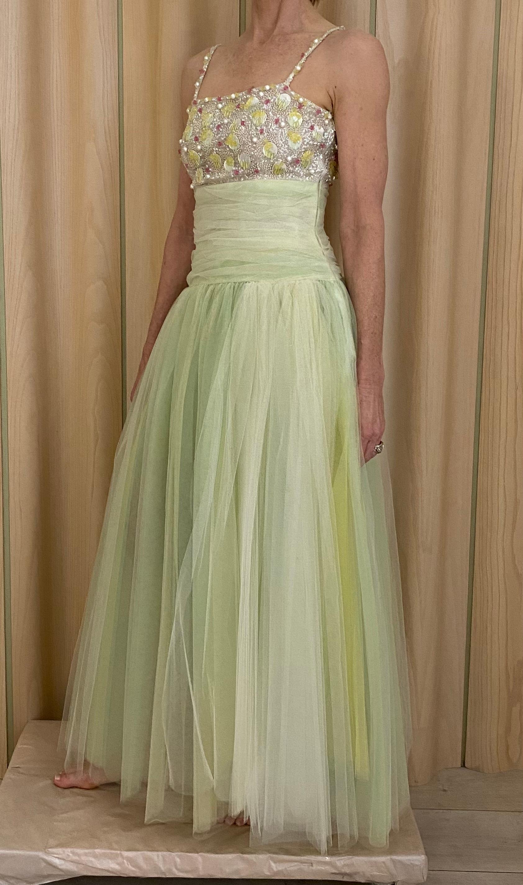 90s Chanel Light green yellow tulle spaghetti strap dress  embellished with pastel Pailletes ( see runway image) perfect dress for Met Gala or wedding. 
Fit size 4/6
Bust: 35”/ Waist 28”
