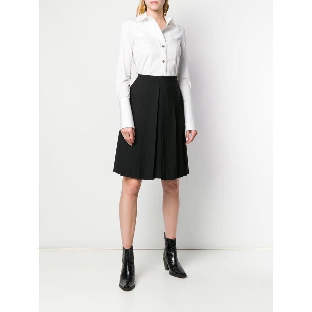 Chanel black wool blend skirt. High waist, side closure with zip and logoed button and pleated decoration.

Size: 44 IT

Flat measurements
Height: 59 cm
Waist: 40 cm

Product code: A7017

Notes: The skirt shows a small hole in the fabric as shown in