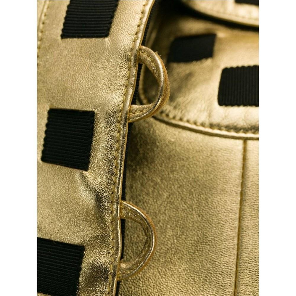 90s Chanel Vintage gold-tone leather jacket hemmed with black details 1
