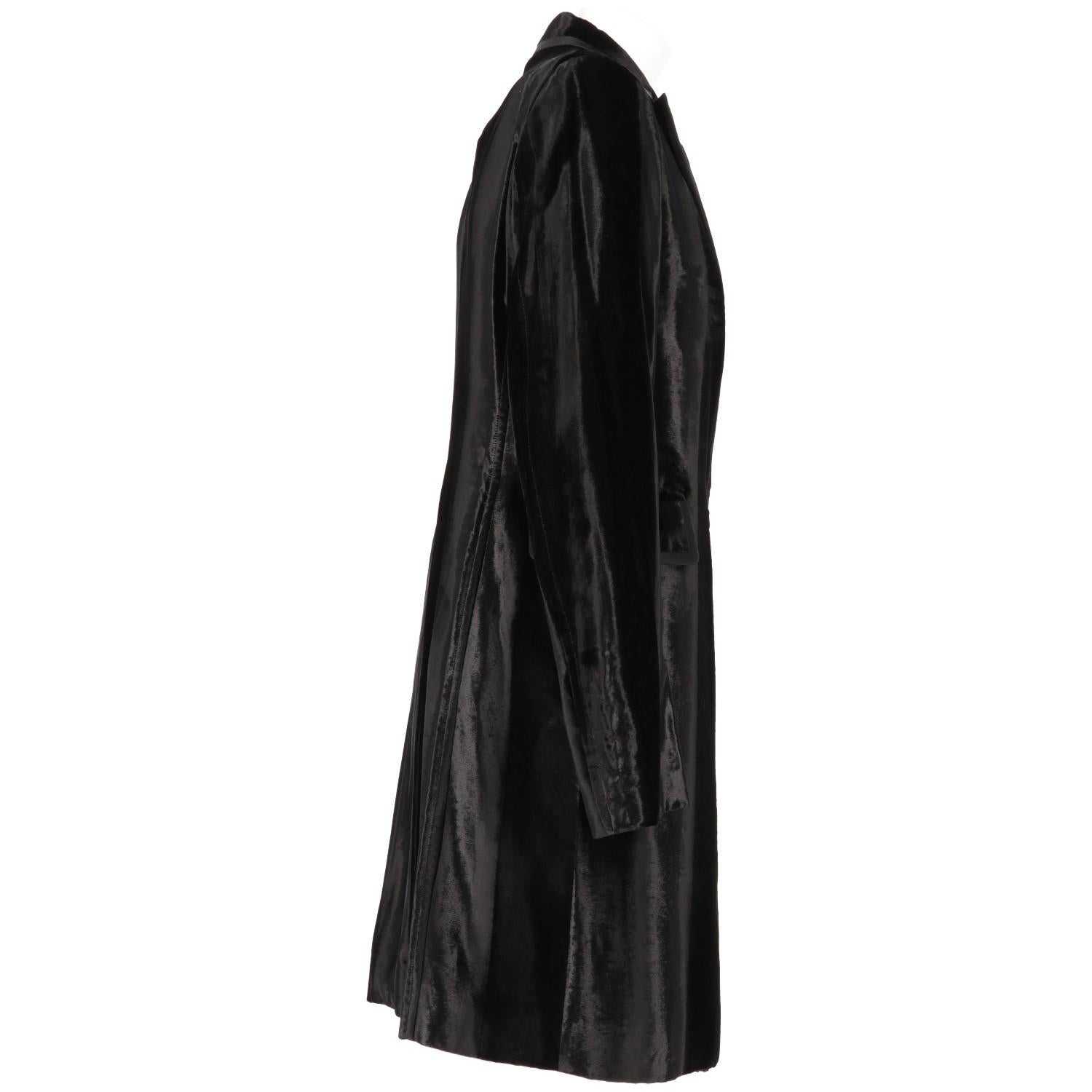 Costume National 90s vintage black cotton velvet coat, regular fit, lance lapel collar, double-breasted lacing with buttonhole and button placket, two front flap pockets, long sleeves with four internal buttons on the wrist and edged profiles. On