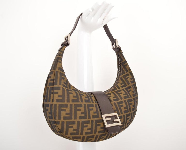 Vintage 1990s FENDI croissant shaped hand bag in the iconinc FF Zucca print. 
 
Features;
Adjustable shoulder strap
Zip fasten closure with 
Typical FENDI FF metal hardware Buckle
FENDI embossed hardware
Zucca print fabric
Nylon & Leather interior
