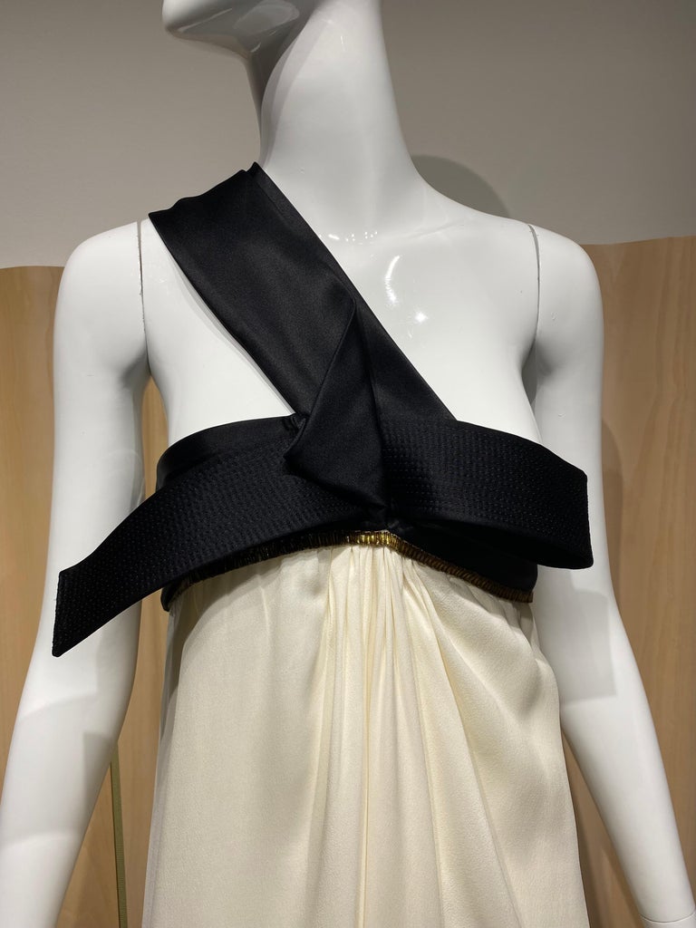 90s Gianfranco Ferre Creme Silk Gown with Black origami pleats asymmetrical evening gown.
marked size 42 ( see measurement) Fit size 6/8
Bust: 34” / Waist : 36 / Hip open / 
Dress length Front : 57” and back length 59”