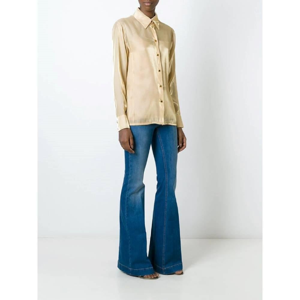 Jean-Louis Scherrer beige shirt with classic collar and long sleeves. Front closure and cuffs with gold-pleated logoed buttons.

Size: 48 IT

Flat measurements
Height: 73 cm
Bust: 47 cm
Shoulders: 41 cm
Sleeves: 65 cm

Product code: