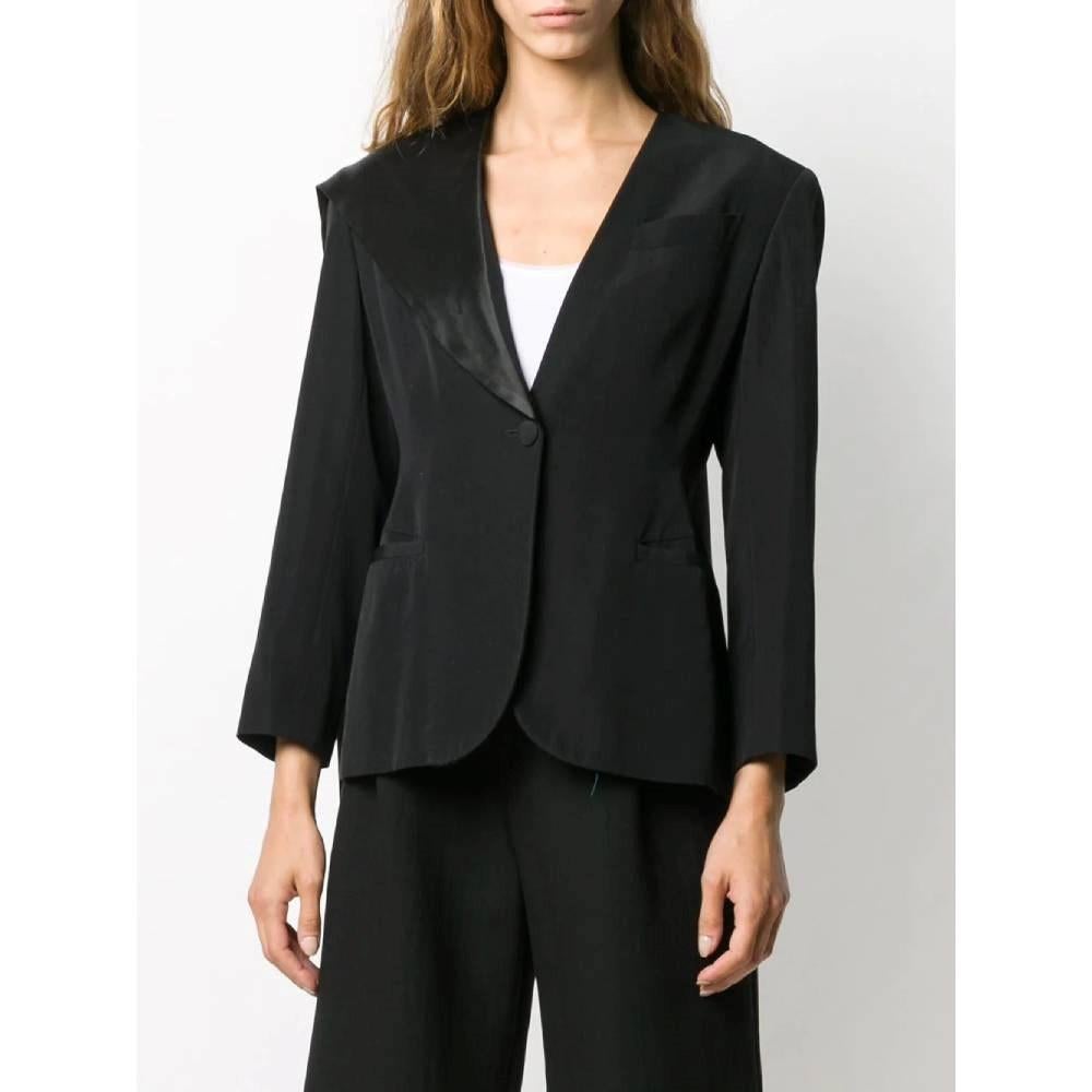 Jean Paul Gaultier black wool jacket with asymmetrical revers collar and padded shoulders. Frontal covered button closure, three frontal welt pockets, one on the heart. Asymmetrical hem.

Size: 42 IT

Flat measurements
Height: 42 IT
Bust: 45