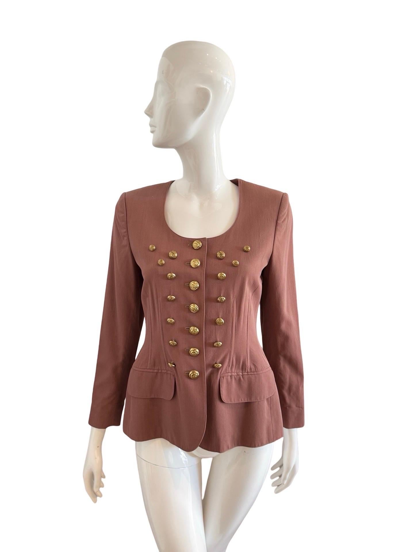 Lolita Lempicka is a French Fashion label founded in 1983 and known for its playful and feminine designs.

This is such a unique design with the brass color swirl buttons in surreal placement all over the front of the blazer.  It feels very Dali in