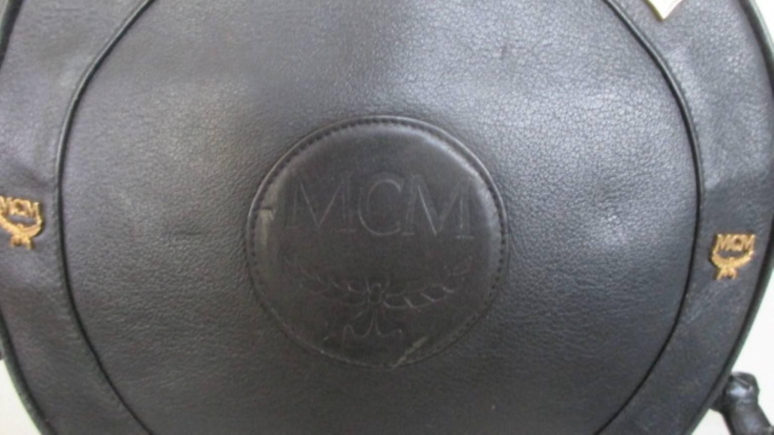 Vintage 1990 MCM Suzy Wong cross body bag -collectors item- designed by Michael Cromer, Munchen
Color: black soft leather
Gold hardware logo studs and fringes
Inside has 1 zipper and 1 open pocket
Condition is fair with minor wear at the gold