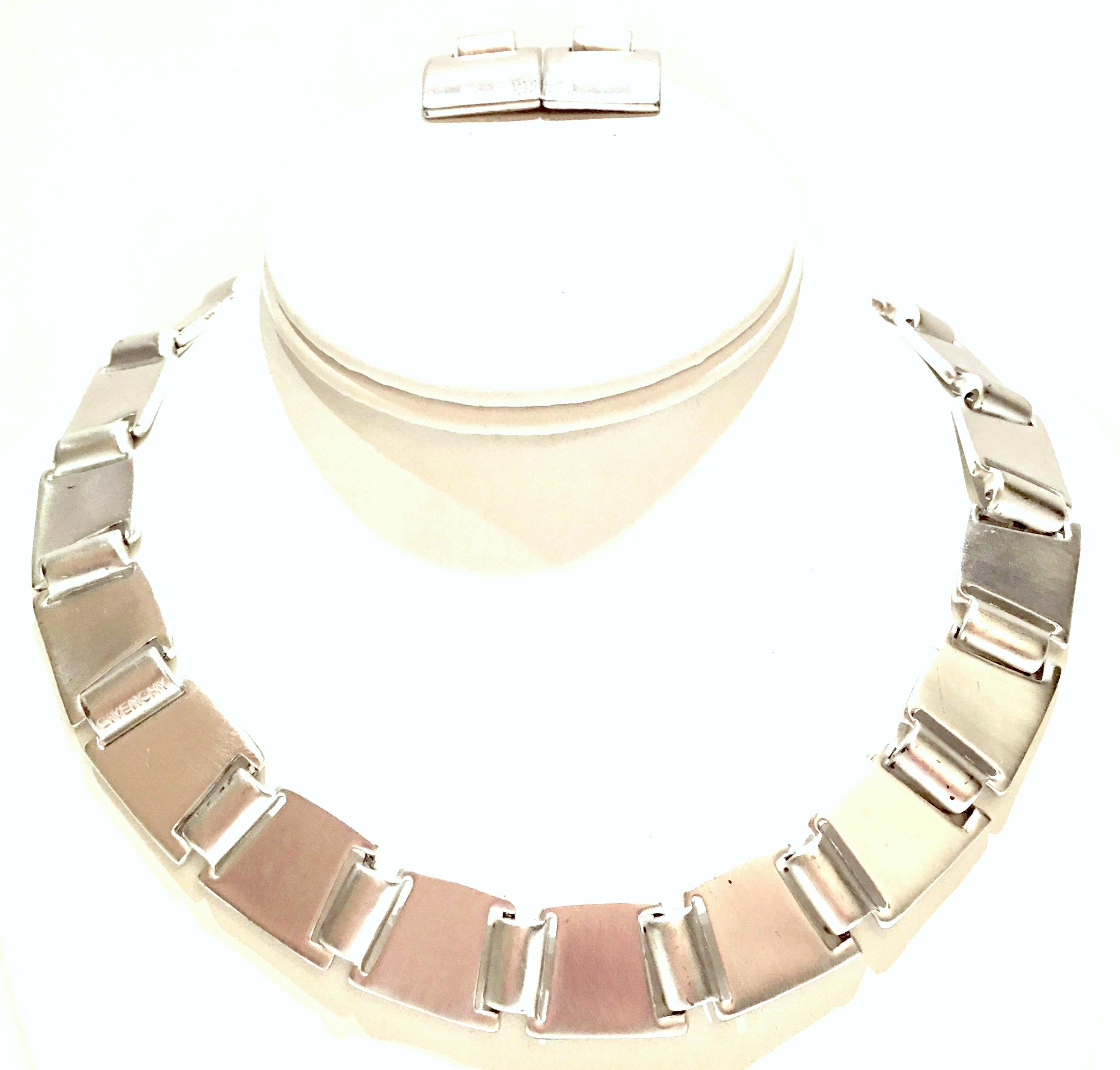 Rare 1990'S Givenchy Modernist signed brushed silver metal square disc link necklace and earrings set. The earrings are pierced back style and feature the Givenchy logo and each piece is signed. The necklace is signed on the underside as well as an