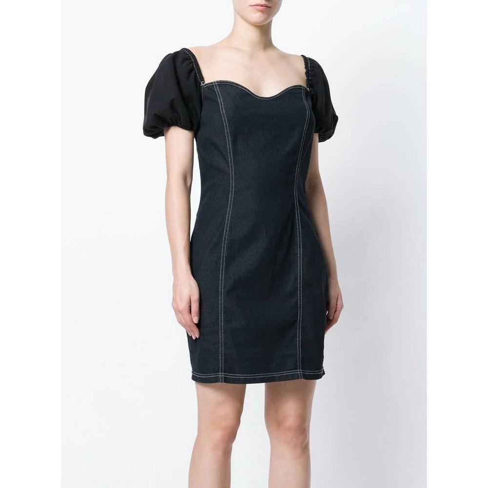 Moschino black cotton blend denim dress with white decorative stitching. Sweetheart neckline, short balloon sleeves and side zip closure. Wide neckline on the back with corset style laces.

Size: 44 IT 

Flat measurements 
Height: 90 cm
Bust: 45