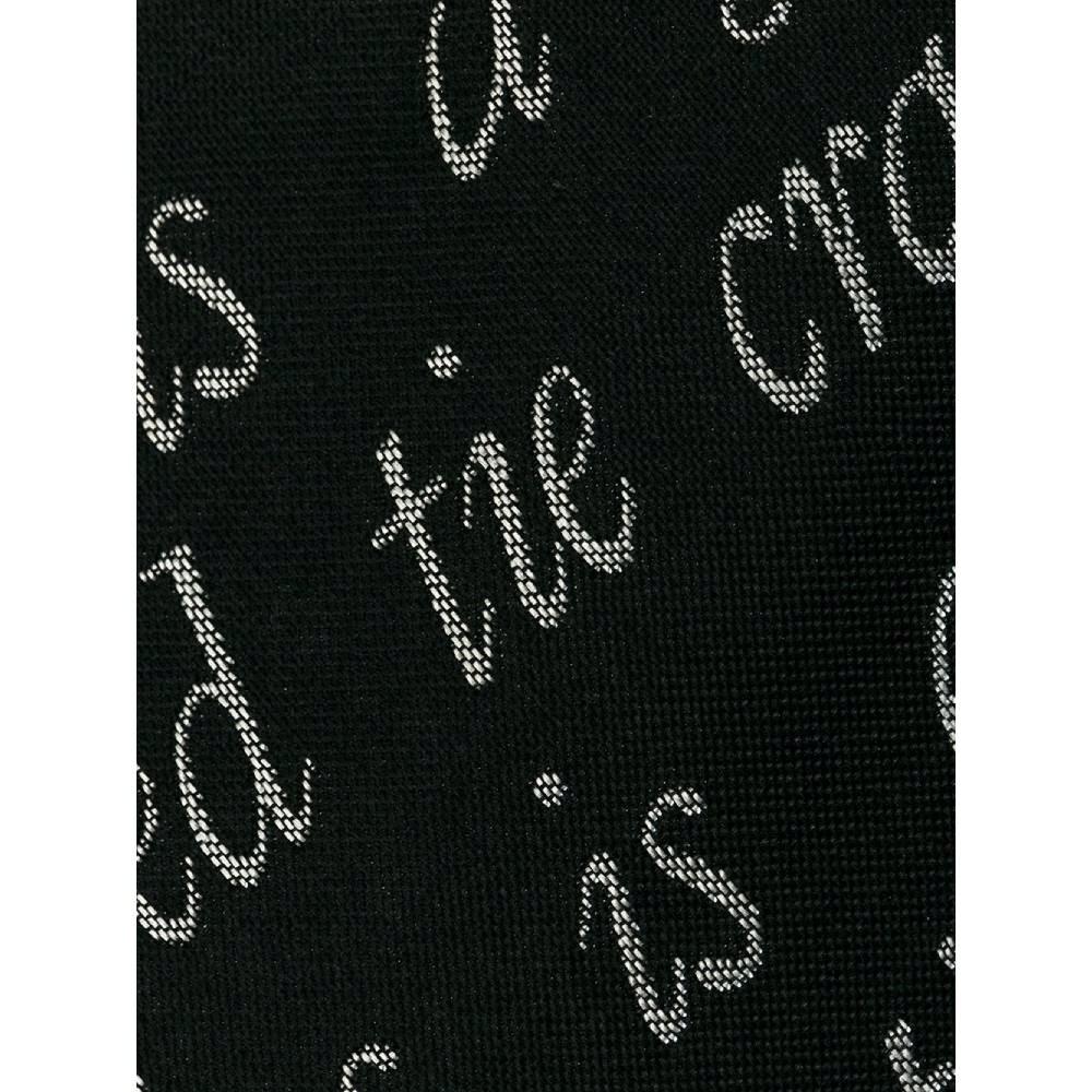 90s Moschino black silk tie with lettering print. Pointed design model.

Measurements
Width: 9 cm

Product code: A6446

Composition: 100% Silk

Made in: Italy

Condition: Very good conditions