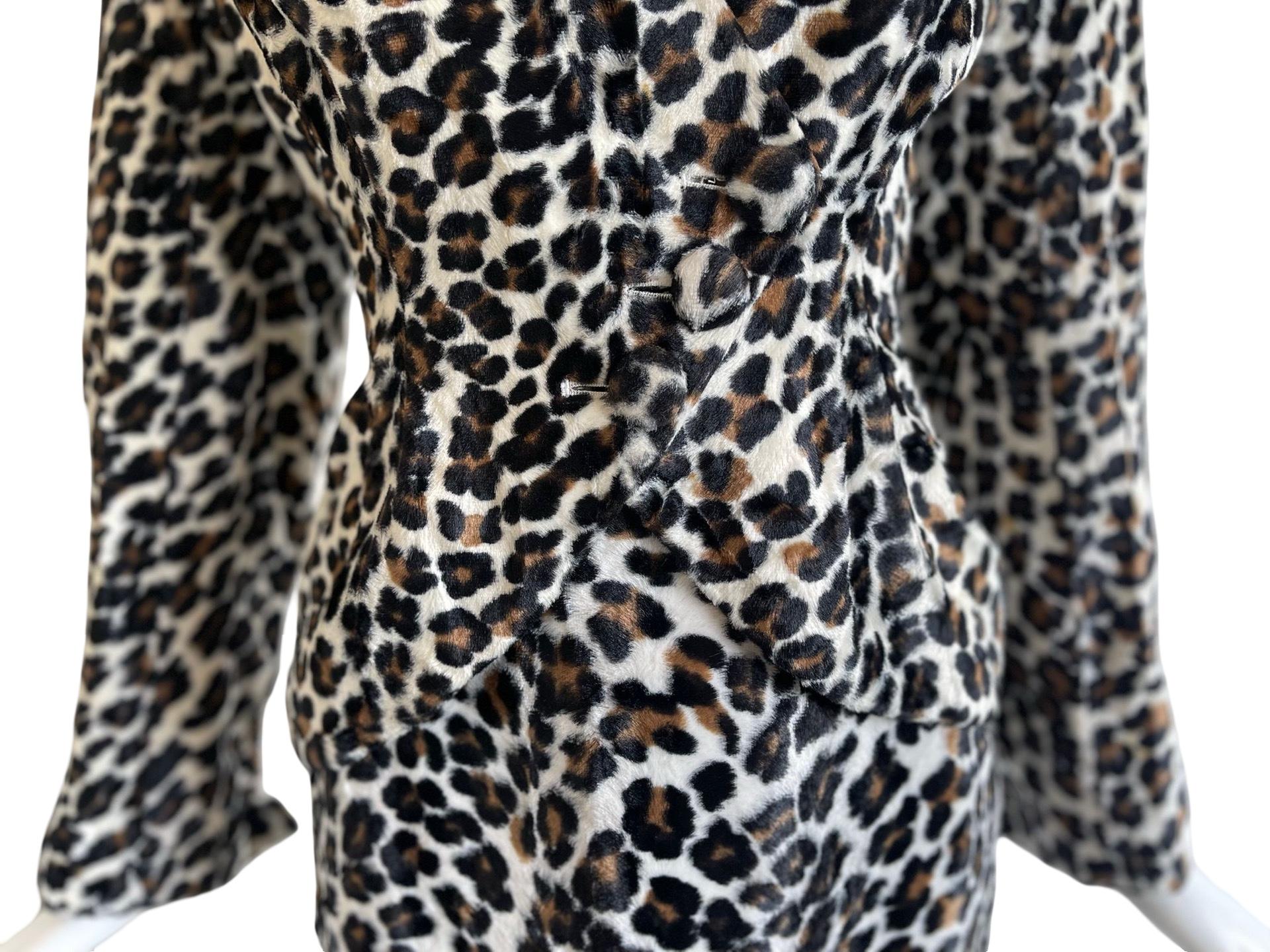 Extra WOW Norma Kamali skirt suit in a fuzzy faux fur leopard fabric.  The jacket has a powerful shoulder and asymmetrical button closure in the front and nips in at the waist. Gives an hourglass silhouette.  The buttons are covered in the same