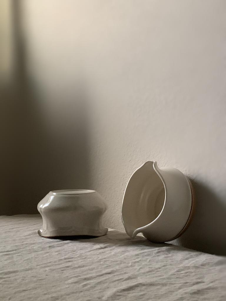 The pair includes two distinct pieces that perfectly complement each other. Their unique shapes and sizes make them versatile and suitable for various uses. The smooth and lustrous glaze enhances the visual appeal of the ceramics, creating a
