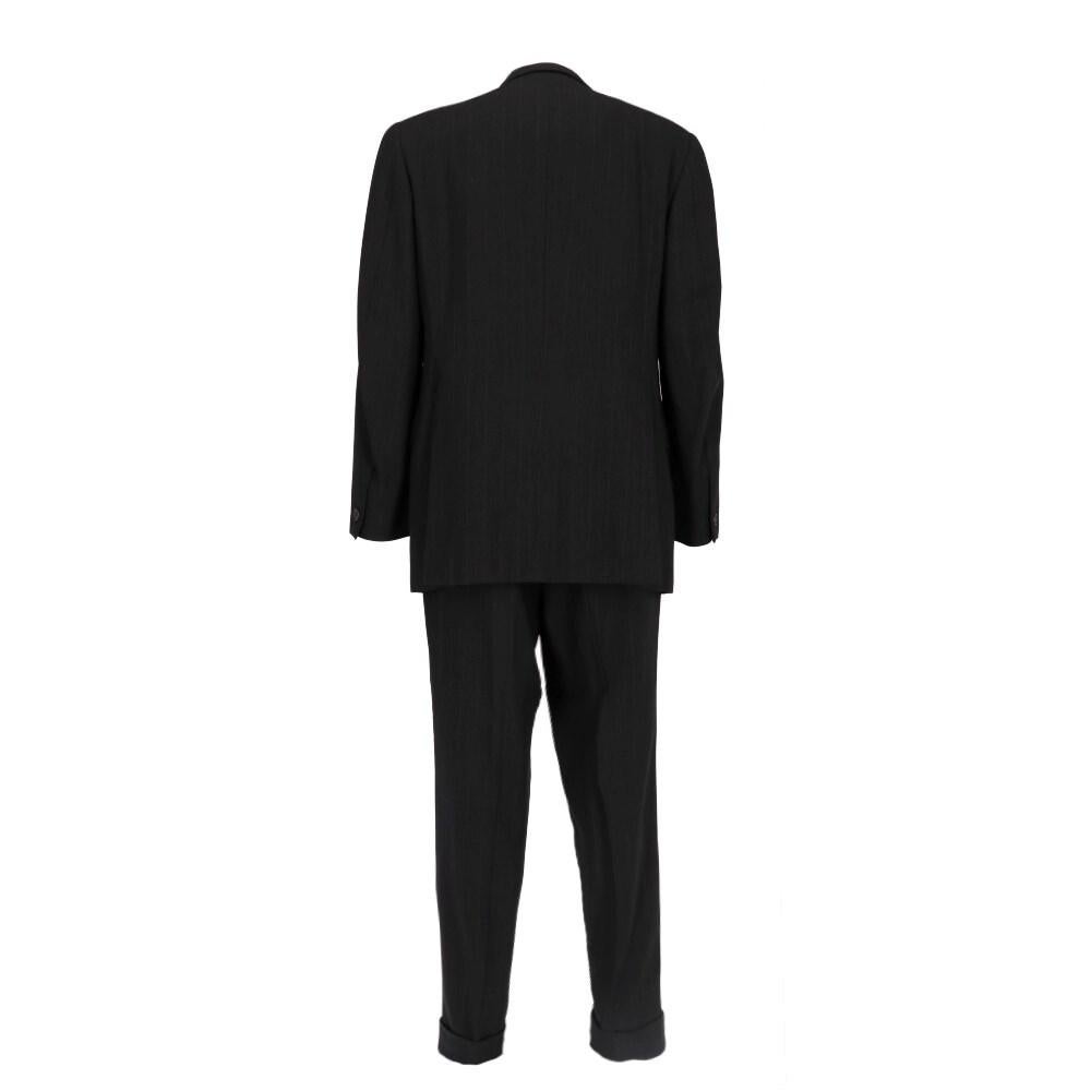 Romeo Gigli black pinstripe wool suit. Classic lapel collar jacket and front button closure. Trousers with front pleat and button closure.

Size: 50 IT

Flat measurements

Jacket
Height: 86 cm
Bust: 57 cm
Shoulders: 46 cm
Sleeves: 67