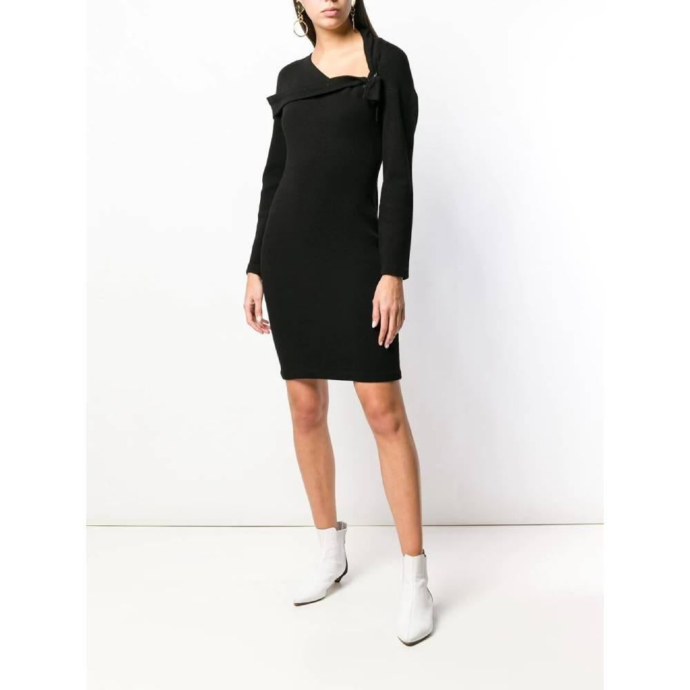 Romeo Gigli black wool dress. Asymmetrical neckline with drapery and bow. Long sleeves and snug fit.

Size: 42 IT

Flat measurements
Height: 91 cm
Bust: 43 cm
Shoulders: 47 cm
Sleeves: 47 cm

Product code: A6028

Composition: 100% Wool

Made in: