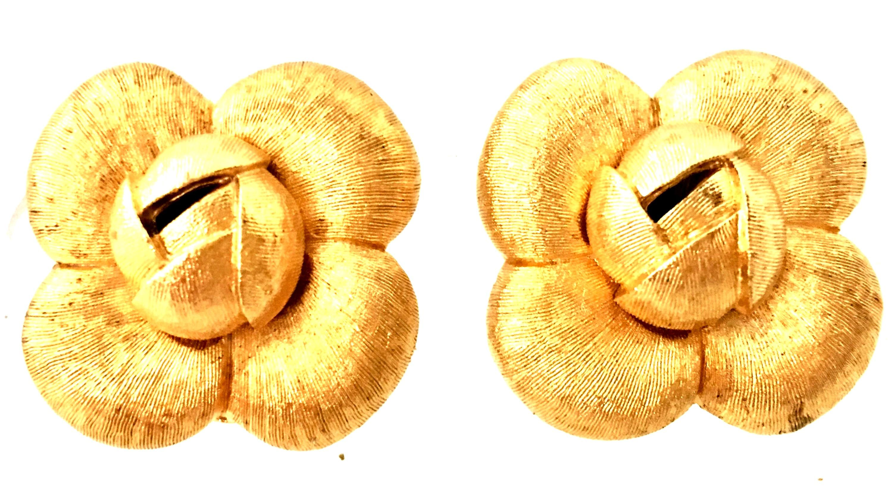 1990'S Organic Modern Brushed Gold Plate Abstract Flower Earrings By, St. John. Features a dimensional and abstract flower form finished in brushed gold. Each clip style earring is signed on the underside, St. John.