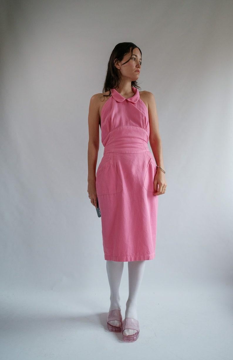 True Vintage Thierry Mugler Paris
Hot pink denim collard halter neck dress
this is giving me dungarees meets couture. 
button collared neck, corset style bodice and pockets. 
Beautifully made and high in the details and deliciously Mugler 
Pictures