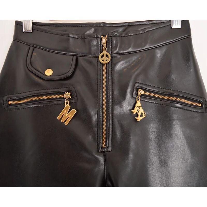 Epic Vintage 1990's Moschino leather look high waisted latex pants, featuring various Iconic Moschino metal hardware logo details. 

MADE IN ITALY !

Features:
Zip up front
Iconic Moschino zip charms
Ultra high waisted fit
Back pocket
Faux