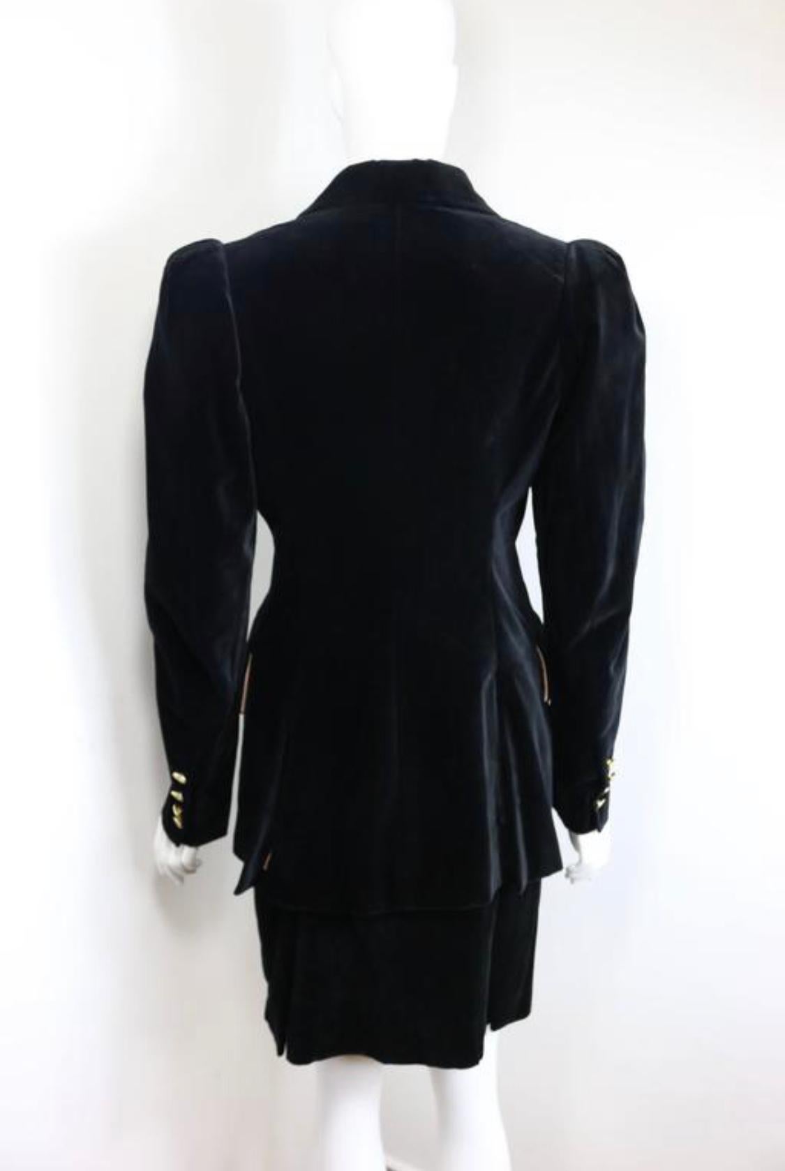 - 90s Vivienne Westwood black velvet double breasted and skirt ensembles. The statement victorian style broad shoulder padded is so Vivienne Westwood. 

- Featuring six signature gold buttons fastening and four buttons on each cuff. Two flap