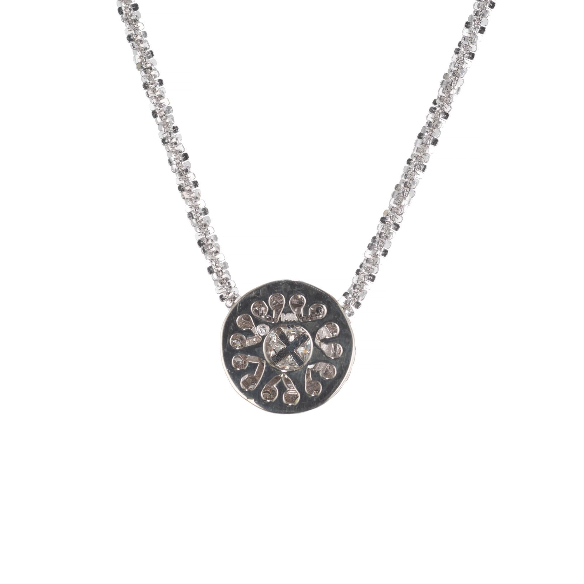 Four trilliant diamond clustered pendant necklace. Center diamonds surrounded with a halo of round brilliant diamonds. Set in 14k white gold on a 14k white gold chain 18 inch chain. 

4 triangular brilliant cut diamonds G-H VS, approx. .55cts
21