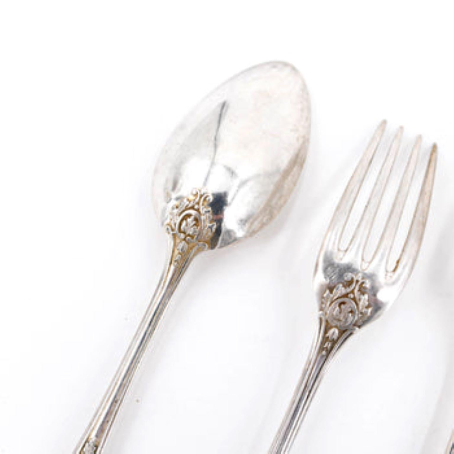 Circa 1860, Paris, France. This 99-piece solid silver set features elegant craftsmanship with crest detail on each utensil.
Measurement is for the knife.