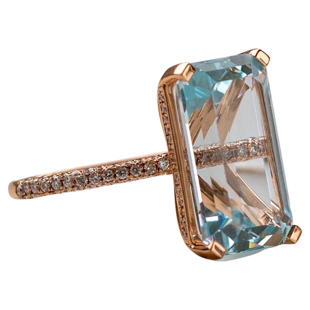 Delicate cocktail ring with incredible sparkle. 

9.10ct Light Blue Aquamarine ring.  
Emerald cut Aquamarine, very sparkly.  
Set in 18K Rose Gold.  
Hidden halo and 3 row micropave half band with diamonds. 
Diamonds 0.48ct total weight, F/G