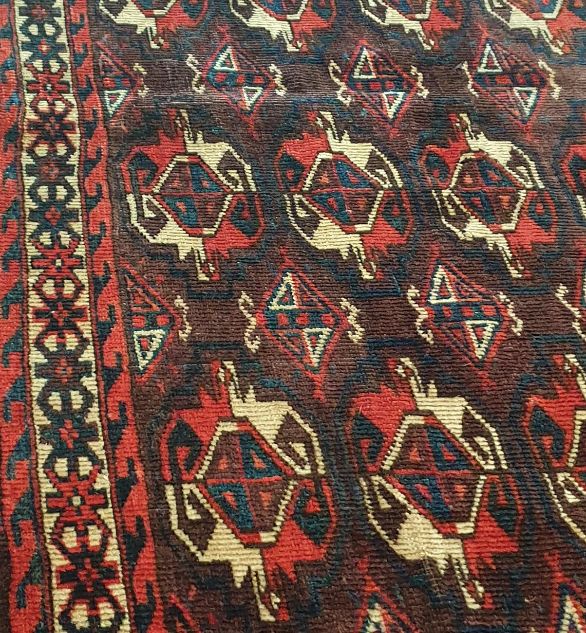 912 - Beautiful Turkmen from the end of the 19th century for horse or Chuval cover, with a nice Bukhara design and natural red field colors, finely hand-knotted with woolen velvet on a wool foundation.