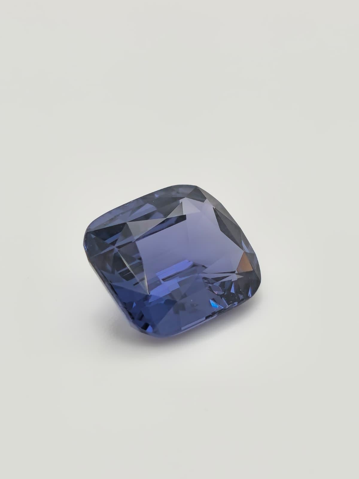 This extraordinary 9.12 carat cushion-cut natural spinel is a true rarity in the world of fine gemstones. Exhibiting a rich and sophisticated blue color,
 this gem possesses a depth and brilliance while offering the unique allure of spinel.
 Its