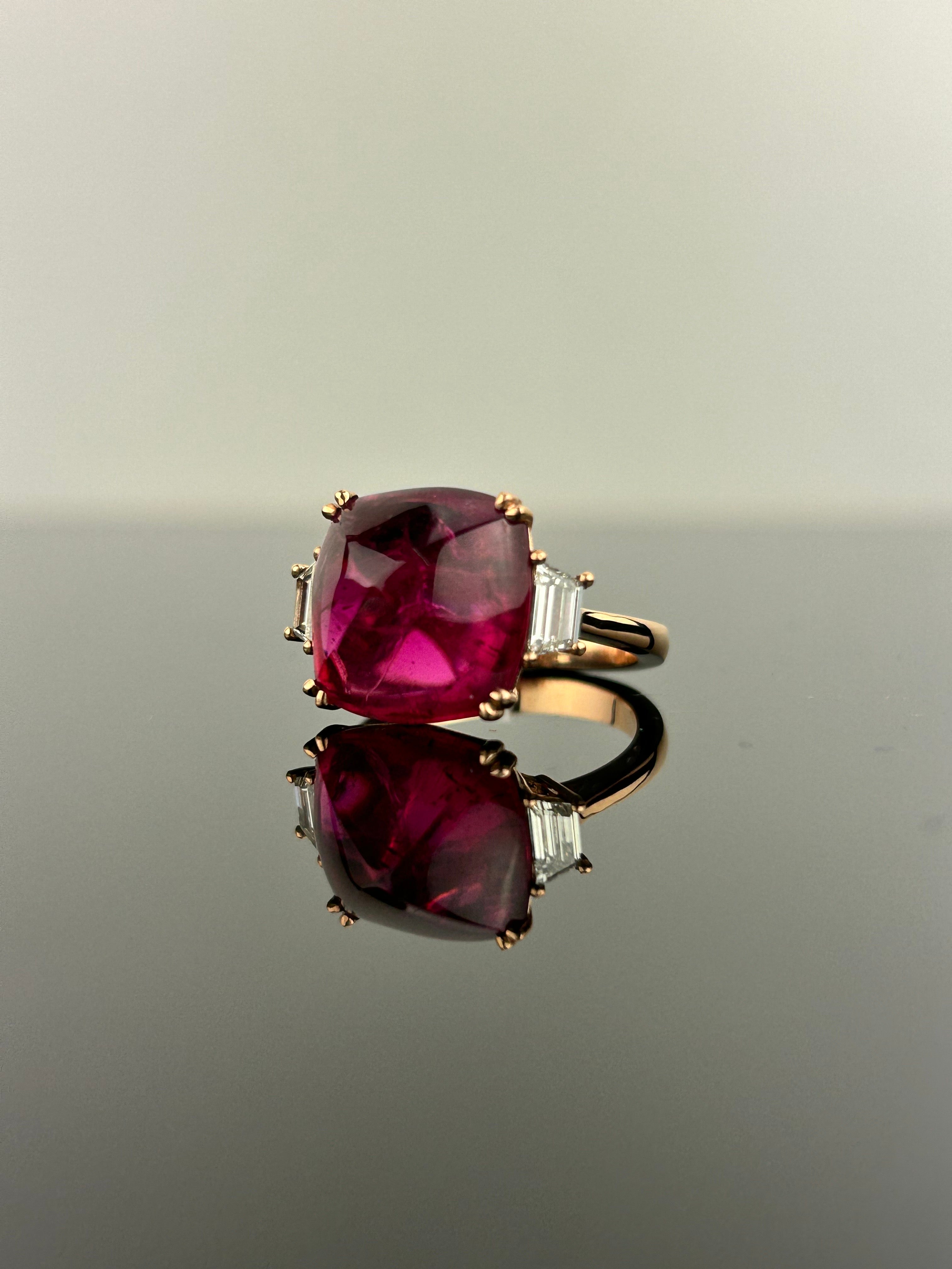 A stunning three stone engagement ring, with a 9.13 carat transparent natural Pink Tourmaline centre stone and 0.50 carat trapeze side stone VS2 quality Diamonds. The Tourmaline is of great lustre and has an ideal pink color. All set in 18K rose